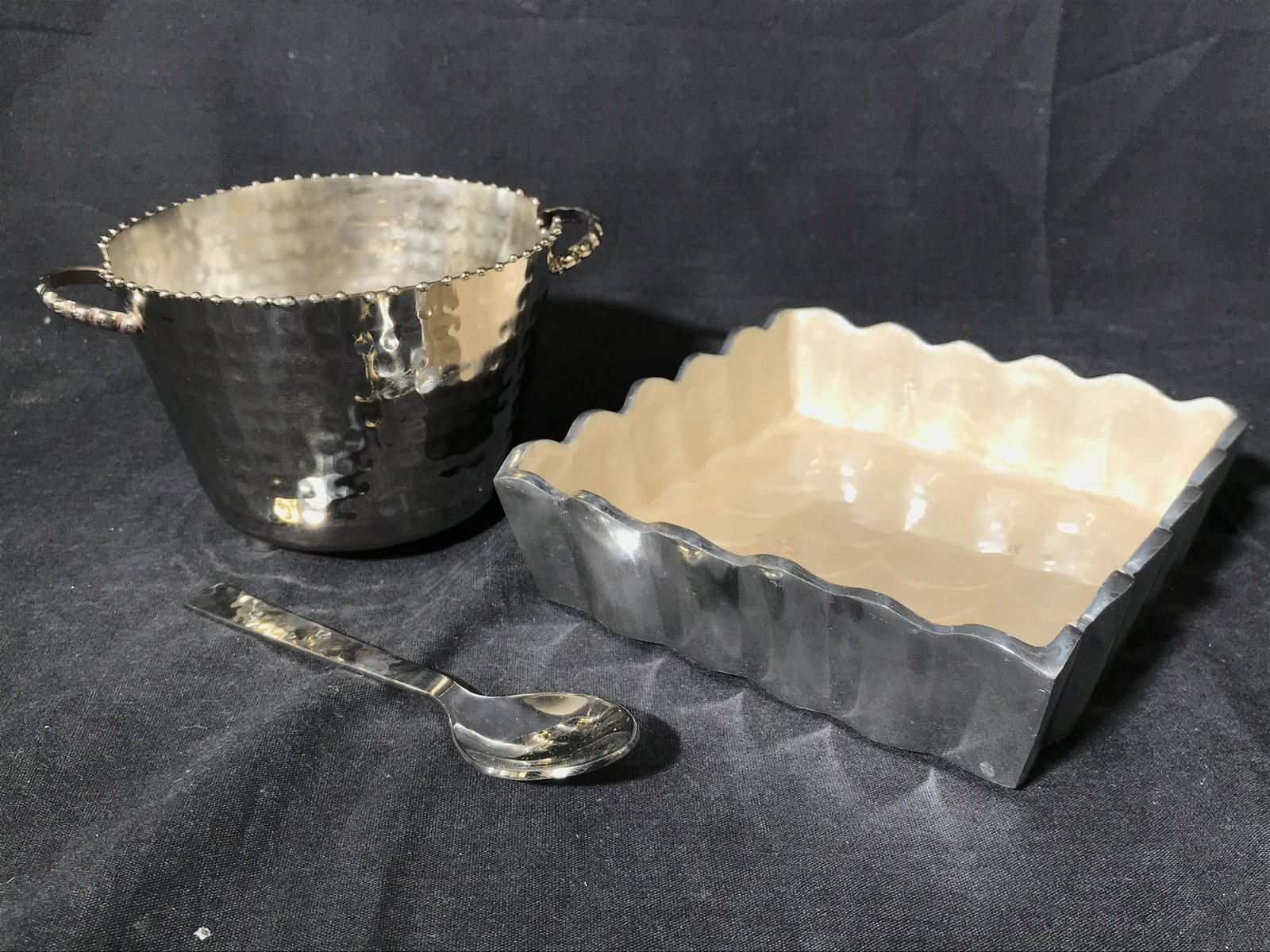 Lot 3 Silver Toned Tabletop Accessories: Lot includes 1 spoon, 1 petite sized bucket & 1 trinket dish. Bucket has 2 handles & 3 feet. Underside is marked TERVY BY CLASSIC TOUCH. Underside of trinket dish is marked JULIA KNIGHT HANDMADE IN IN