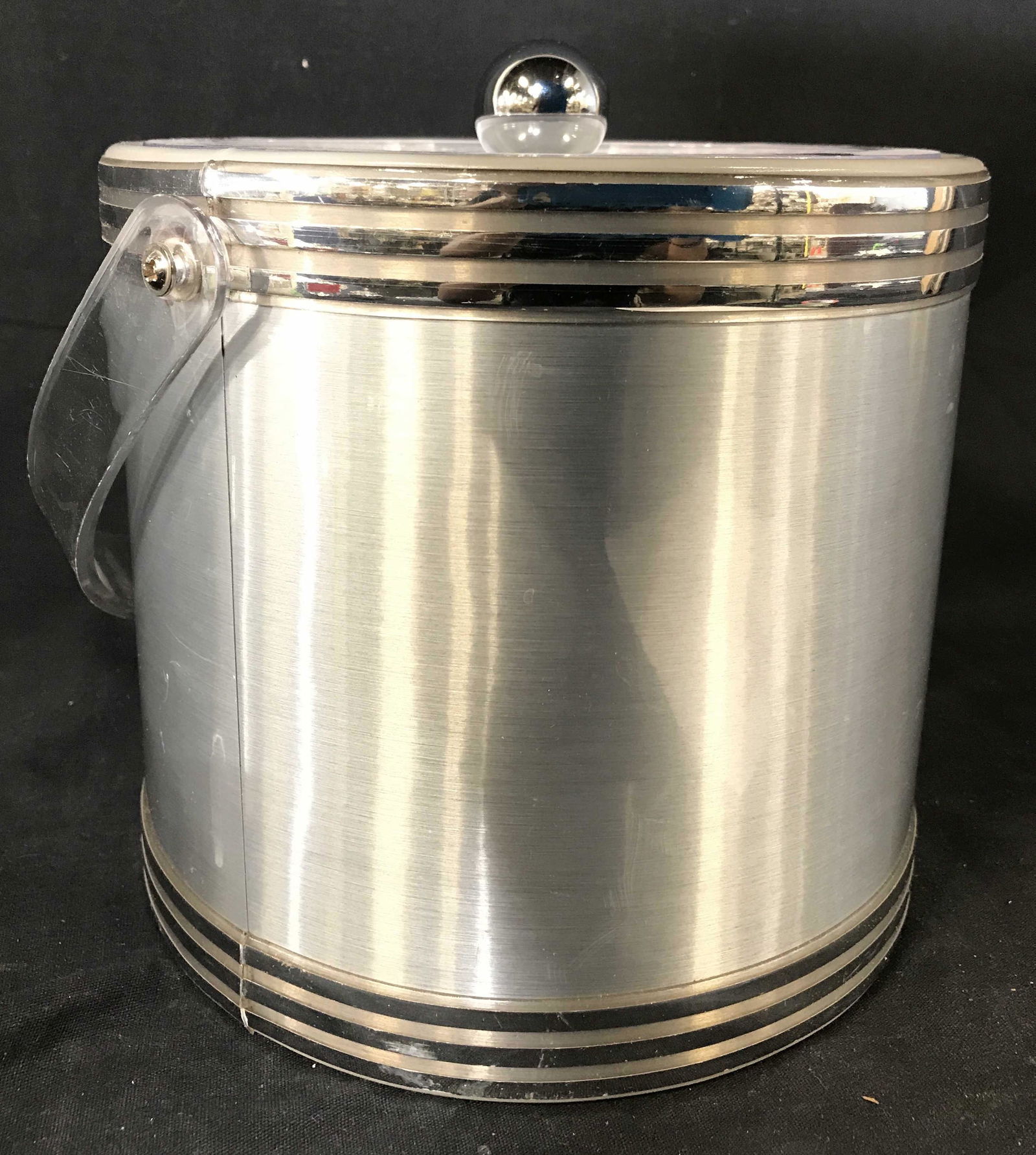 GEORGES BRIARD Lidded Ice Bucket W Handle: Underside of ice bucket is marked GEORGES BRIARD. Ice bucket is in the style of real metal. Handle and lid appear to possibly be lucite. Piece measures approximately 13 inches tall 8 inches wide. Ice