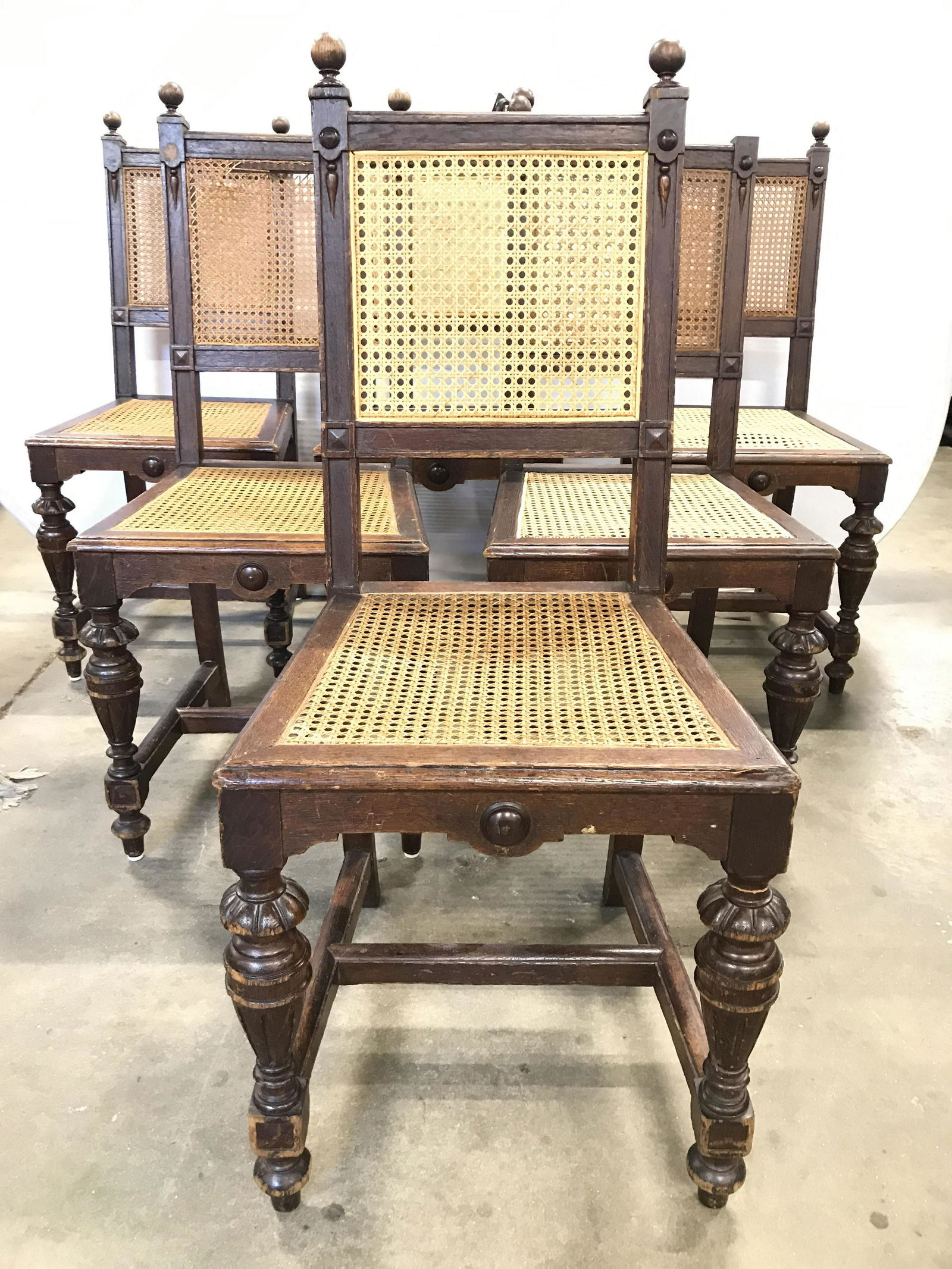 Set 6 Vintage Caned Carved Wooden Side Chairs: Lot includes 6 side chairs. Each have 2 carved wooden finial structures on top of backrest. Seat and backrests are caned. Front 2 legs have carved wooden detail. Each measures approximately 41 inches