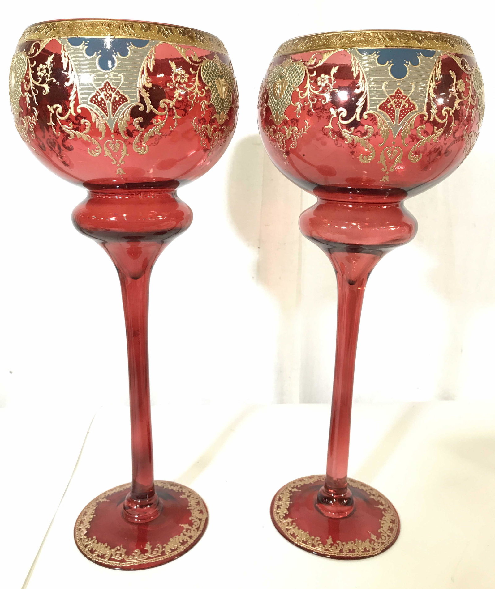Pair Tall Bohemian Glass Goblets, 20 in: Lot includes 2 goblets. Goblets have tall stems. Each piece has gold toned ornate detail with toned of slate blue and olive. Base and goblet basin has c and s scroll ornate detail. Chalices, goblets, 