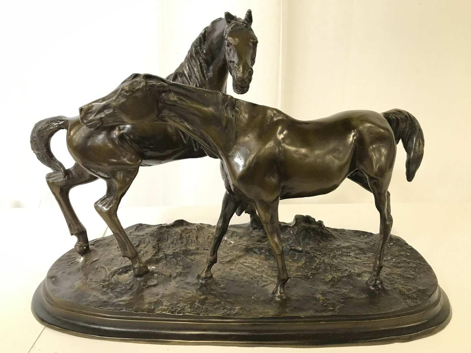PJ MENE Bronze Horse Figural: Piece is signed PJ MENE. Figural is vintage possibly leather. Horse Figural statue appears to be bronze. Piece depicts 2 standing horse figurals. Piece measures approximately 13 inches tall 20 inches 