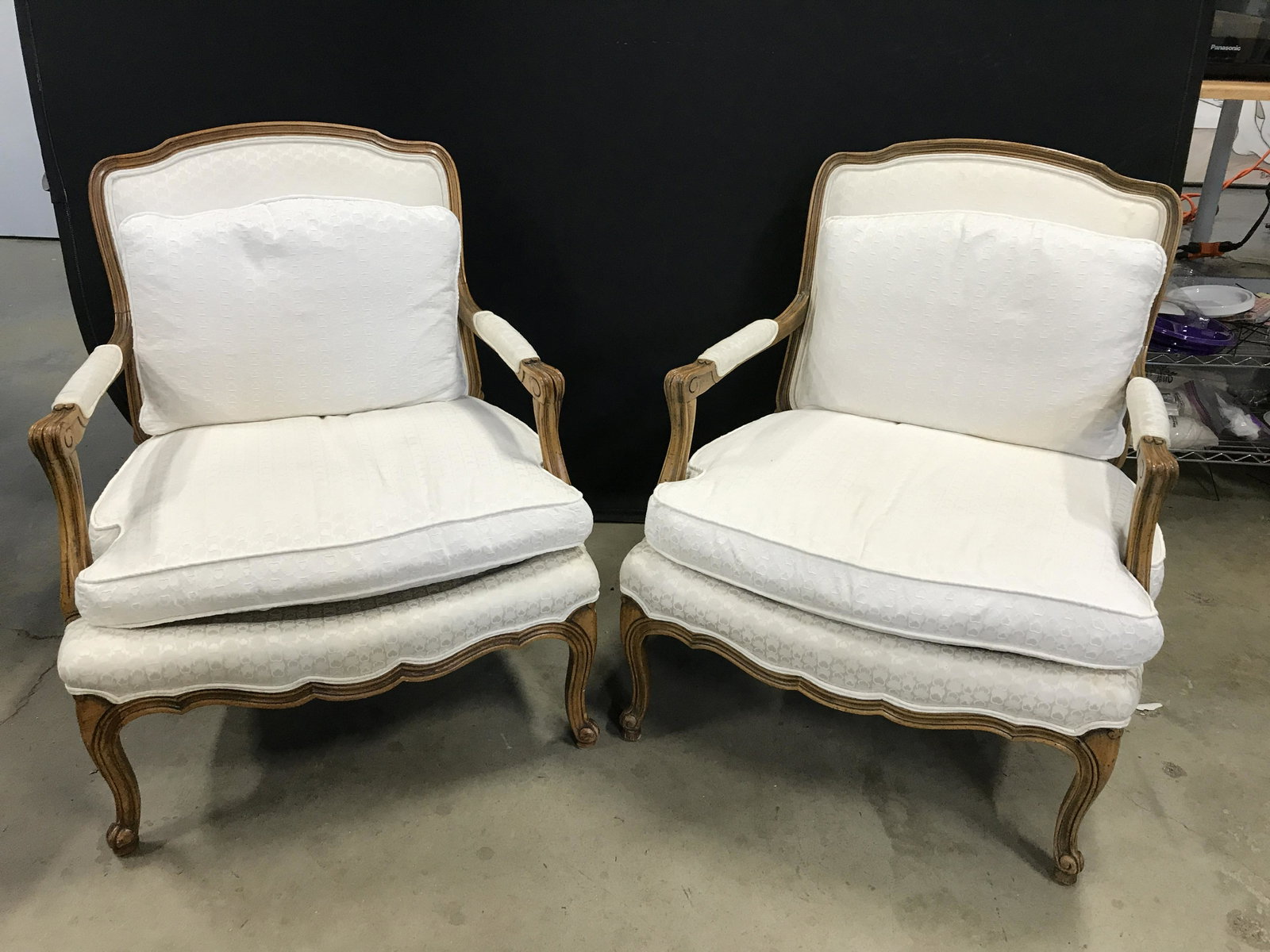 Pair LOUIS XVI Style Vintage Bergères Chairs: Vintage Bergères, possibly antique, removable cushions for both the seat and back are included. Carved wood frame, upholstered armrests, upholstery is double welted. Measures approx 34.25 inches H, 2