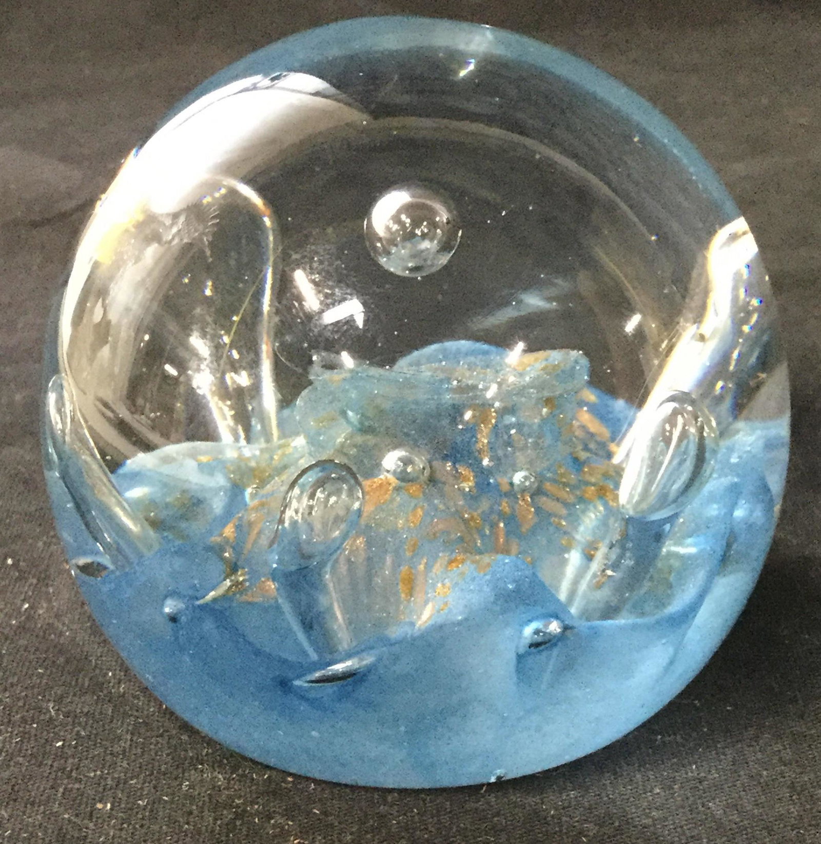 singed Decorative Art Glass Paperweight, Scotland: Decorative art glass paper weight, measures approx 2.5 inches H, and 3 inches W. Gold leaf flecks decorate the piece, resembles a whirling pool of water. Underside reads as CAITHNESS SEADANCE SCOTLAND