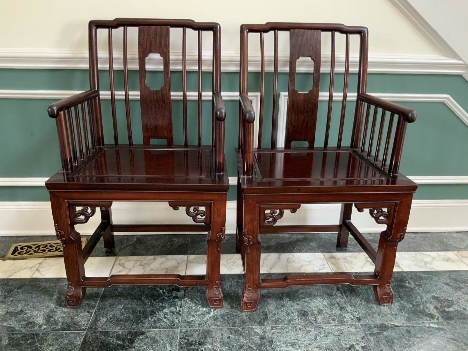 Pair Asian Rosewood Harwood Armchairs: Hall chairs, Arm Chairs, hand crafted heavy wait pair of Asian chairs, open back with parallel rails, tubular arms wit perpendicular rails as sides, carved apron, box stretchers, scroll work to corner