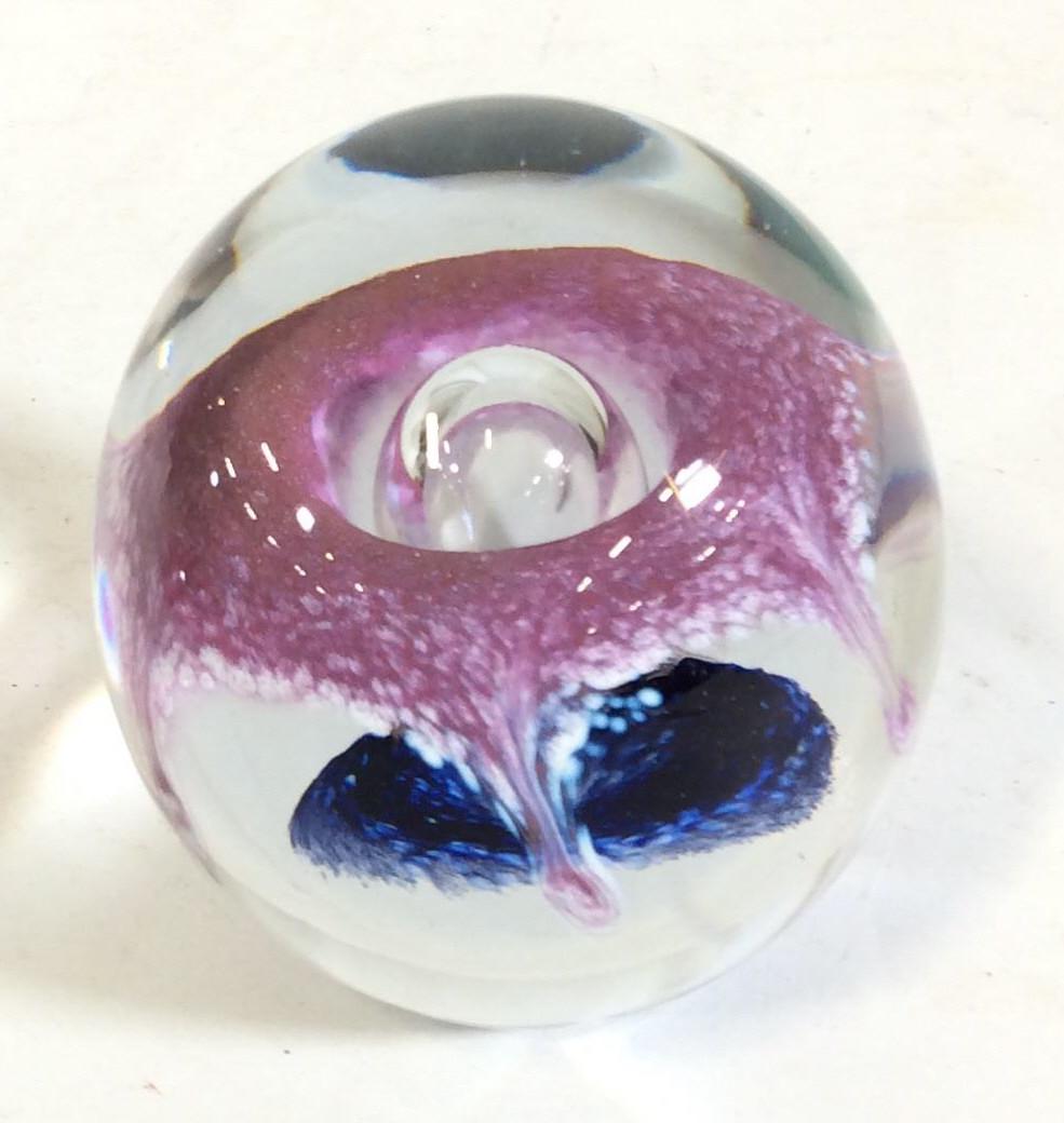 Signed Art Glass Globe Paperweight, c. 1990: Vintage Glass paperweight, Clear Glass with floating purple glass. Center glass bubble designs, Possibly reads ECCHOEO OR EUNKOLT ( otherwise, illegible). App 3 5/8 in ht. Width 3.5 in. Desktop Object