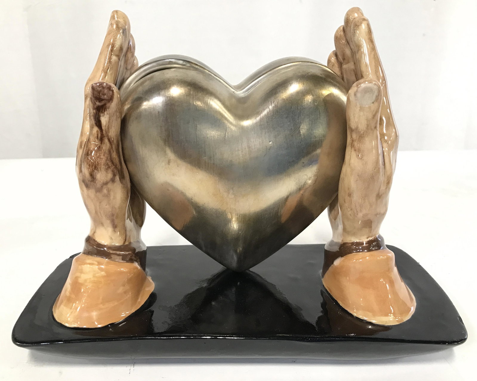 Vntge Signed Heart Trinket Box W Hand Figures: Piece is signed and dated VIVIANE JANUARY 16 1982. Piece is porcelain. Piece has 2 hand figures holding a gold toned heart shaped trinket box. Piece measures approximately 9.5 inches long 7 inches tal