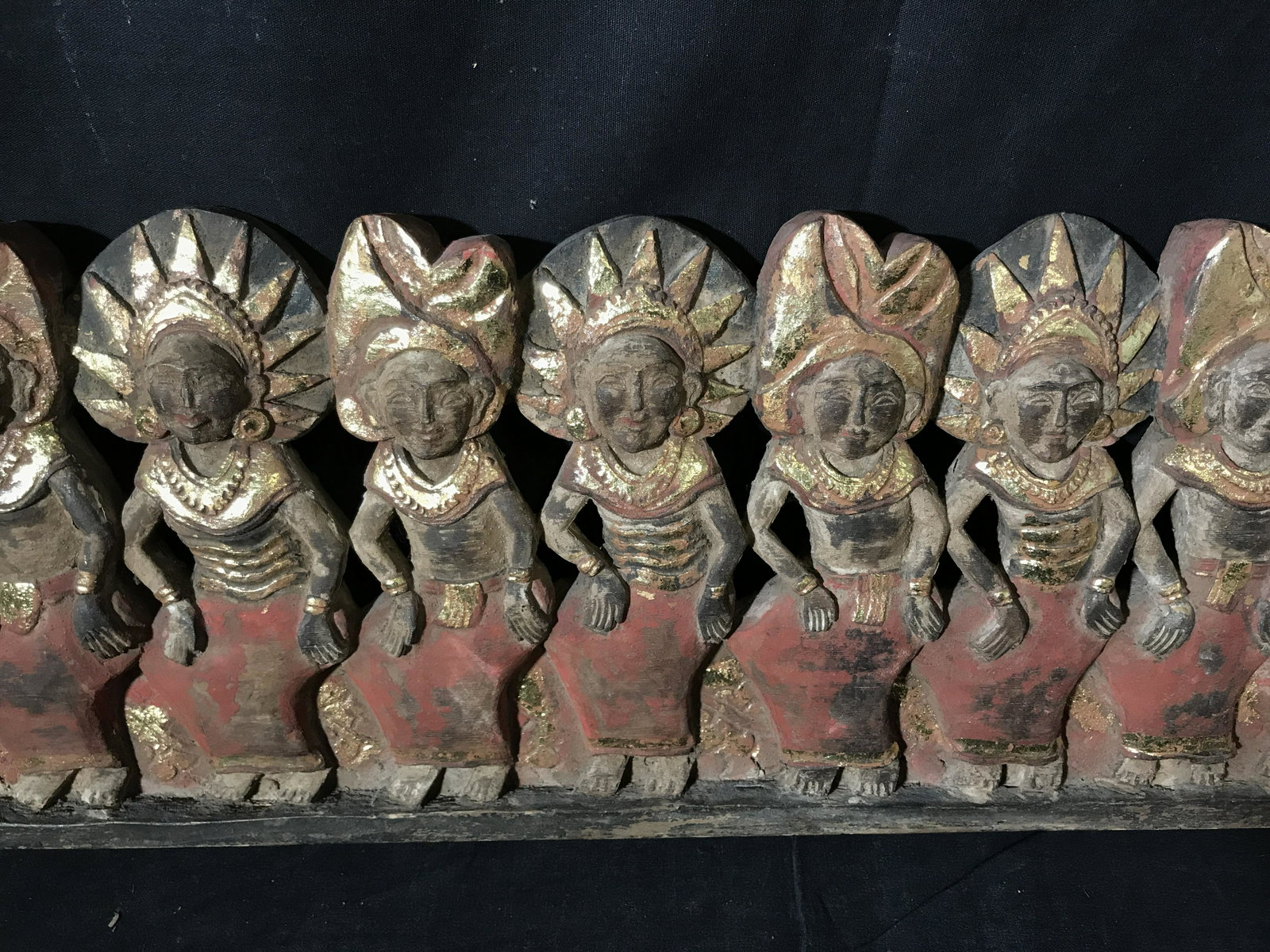 Far East Asian Dragon Boat Procession Sculpture: Far East Asian dragon boat procession sculpture, carved from one single block of wood, possibly Indonesian, sculpture depicts several figures in red skirts and gold jewelry/headdresses seated on a dua