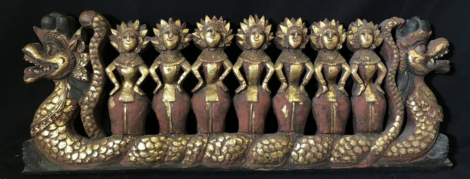 Far East Asian Dragon Boat Procession Sculpture: Far East Asian dragon boat procession sculpture, carved from one single block of wood, possibly Indonesian, sculpture depicts several figures in red skirts and gold jewelry/headdresses seated on a dua