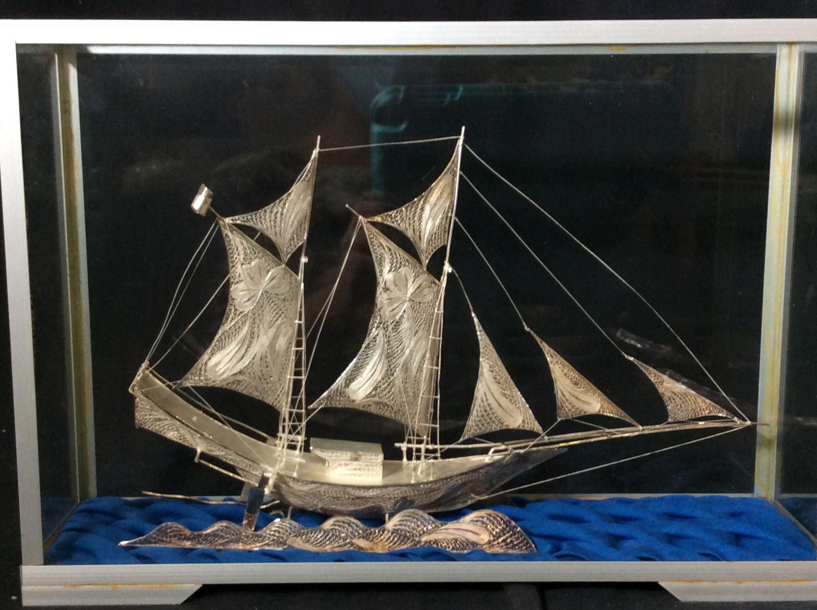Hand Crafted Sterling Silver Sailing Ship Statue: 1800s style sailing ship made entirely of Sterling Silver. Filigree sails, sterling wire, Filigree ocean waves, Sails have Shamrock and paisley design intricately woven in sterling silver. Comes in sh