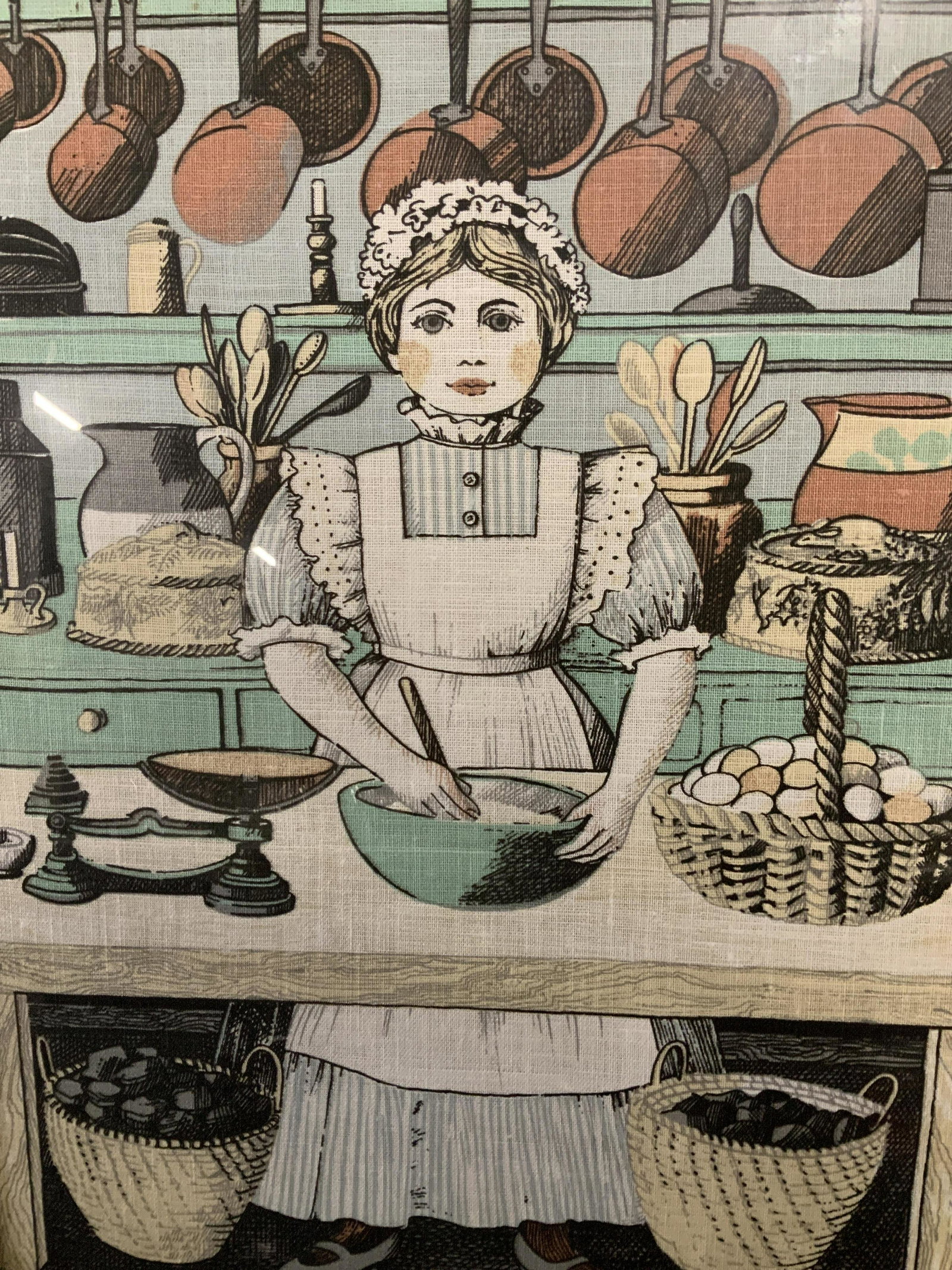 Vintage Style Framed Print on Linen: Vintage Style framed print on linen, stamp to reverse illegible, a maid standing in front of kitchenware, Measures 28 1/4 x 17 1/2 inches, wooden frame painted black, frame has some losses but overall