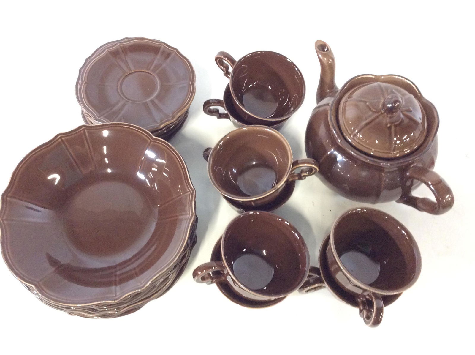 Set Niderviller Maintenon Tea & Plate Set, France: Total pieces- 25 . Niderviller MAINTENON dark brown teapot, cups and saucers and bowls are a solid dark coffee brown, glazed. good condition. Coffee pot 11 x 7. In. Ht. 6 in. Salad bowls-8, tea/ coffe
