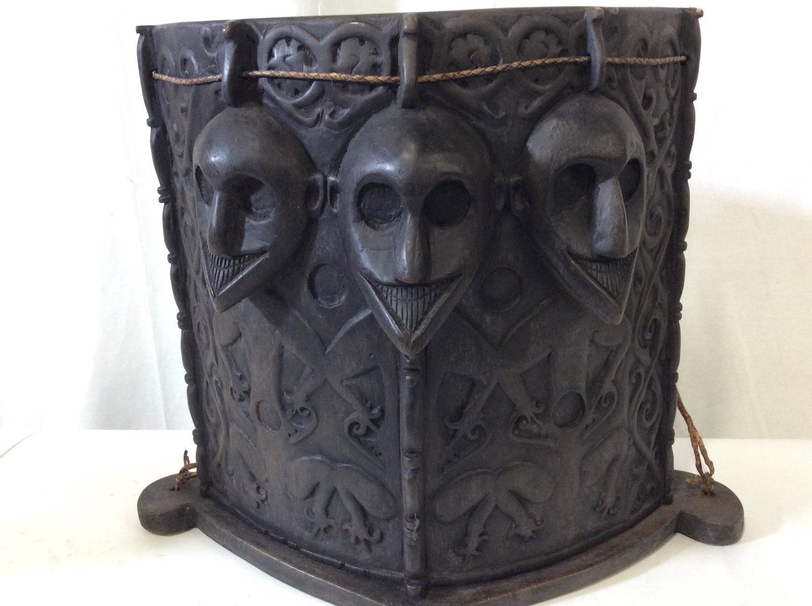 Antique Borneo Ancestor Wood Baby Carrier: Indonesia 19C/20C , possibly antique , Borneo Dayak Tribal Wooden Carved Baby Carrier w Ancestor Motifs. Dark wood, carved for one piece. Braided Grass straps. Measures 16 in. tall, 19 in. across, 5 i