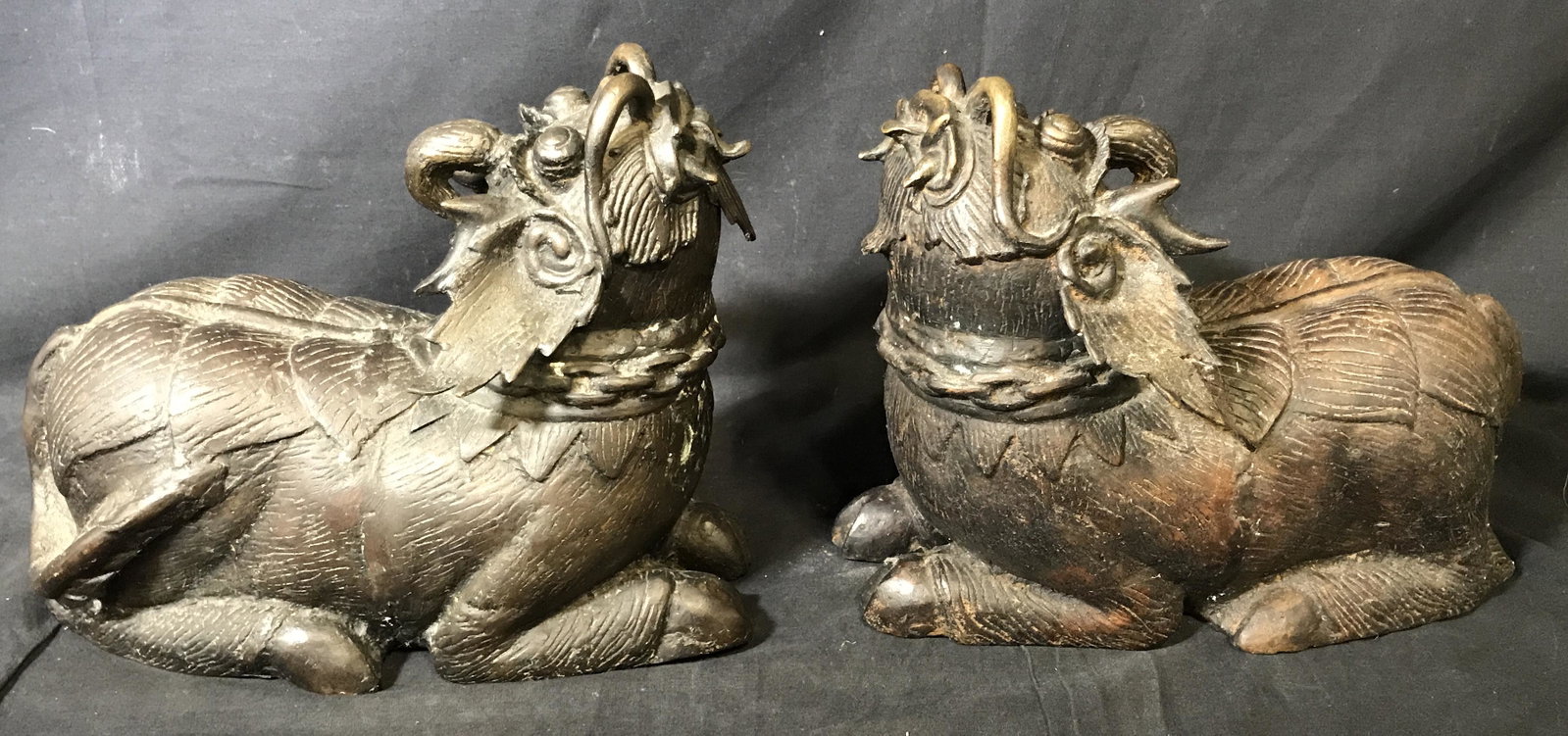 Pair of Bronze Balinese Foo Dogs / Qilins: Pair of bronze Balinese foo dogs, both are hollow, no apparent signatures or stamps, some wear to surface, each wears a chain collar, both of their faces depict a traditional demon face with whiskers 