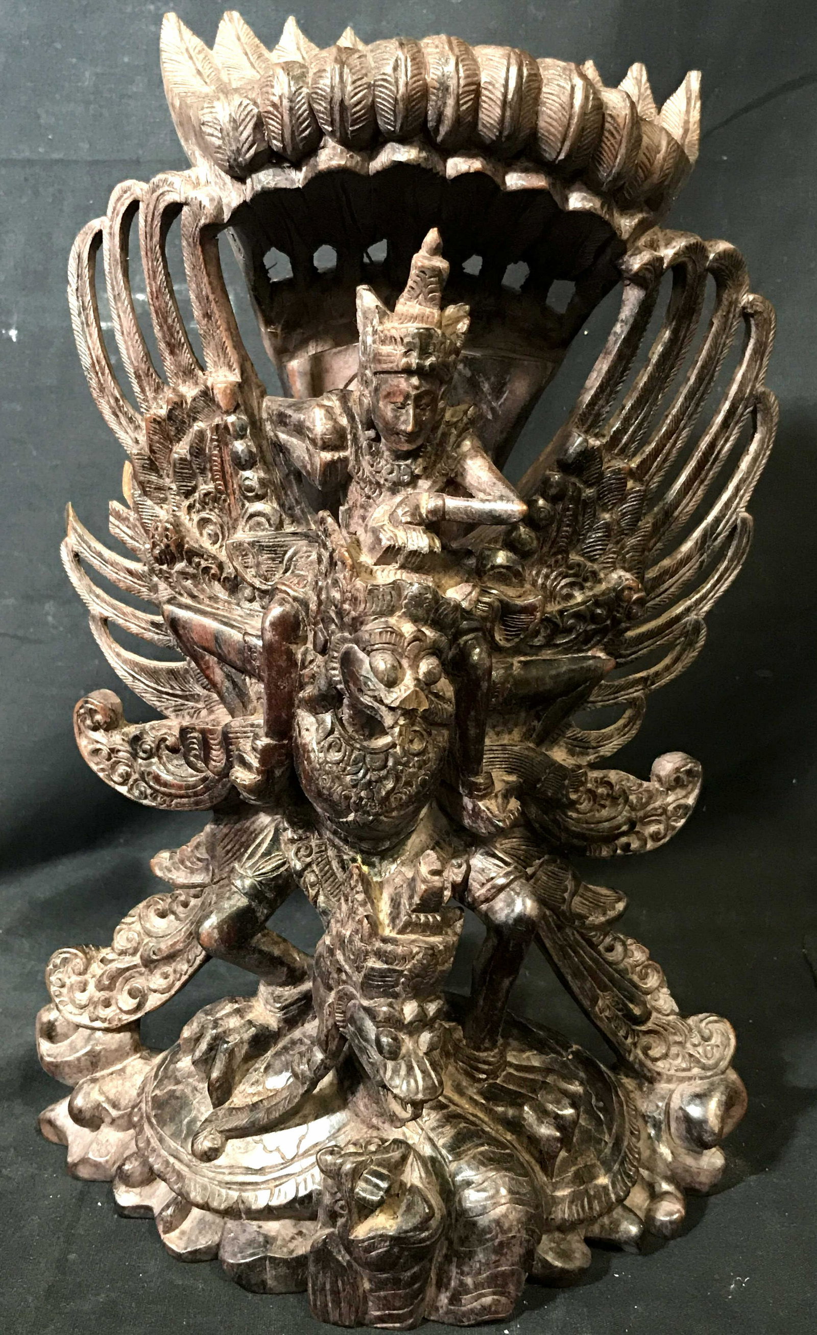 Balinese Wooden Sculpt Vishnu Riding Garuda: Balinese Hindu Wooden Sculpture, carved from a dark purple brown wood, statue depicts the Hindu god Vishnu riding the winged creature Garuda a with a serpent below possibly sumukha, measures approxima
