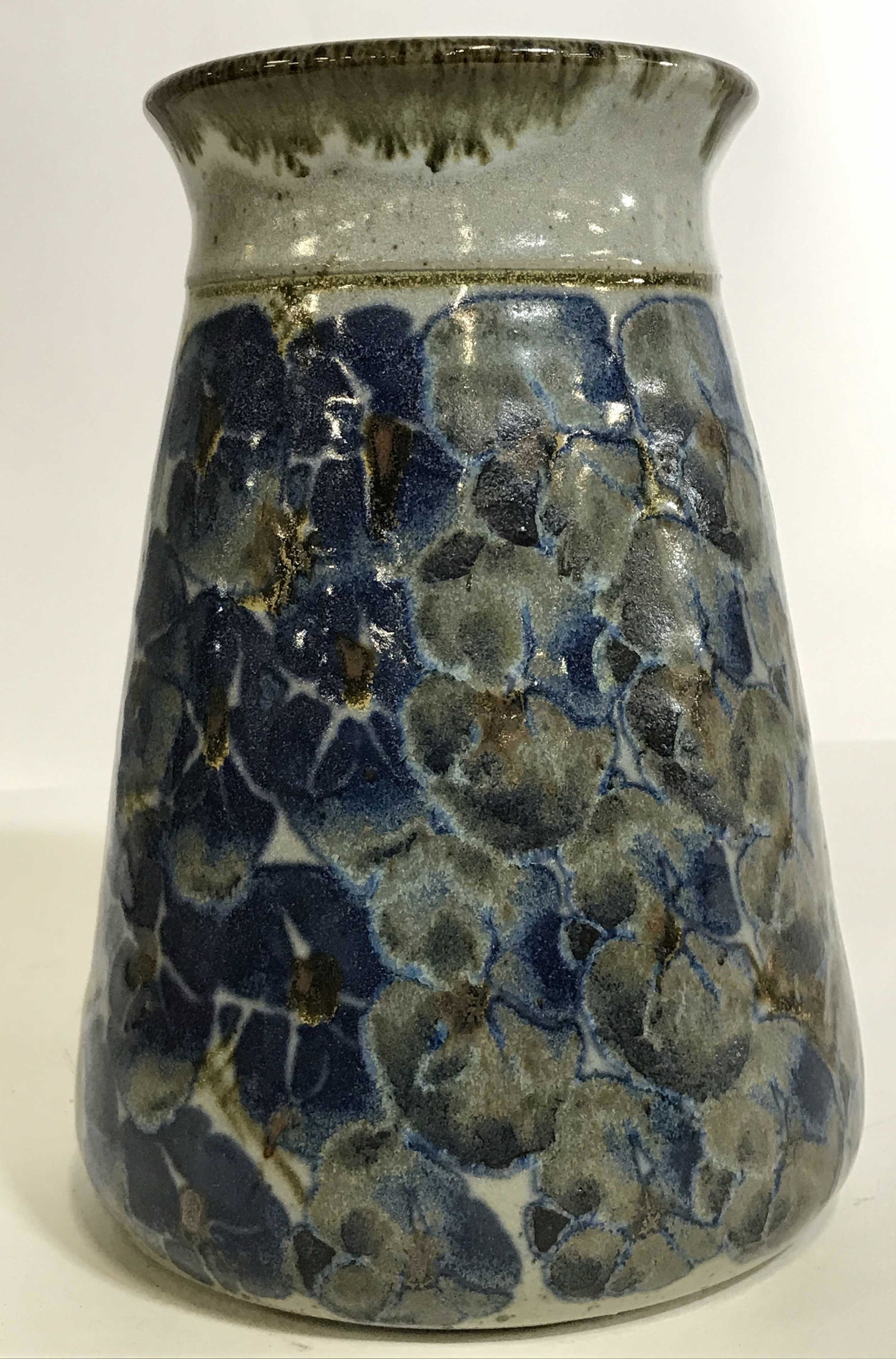 Signed Vintage Art Pottery Vase Wilson: A vintage art pottery vase with an inscribed signature on the bottom, Wilson. This vase has an all over abstract floral design in shades of blue with an interior in a contrasting design and color. The