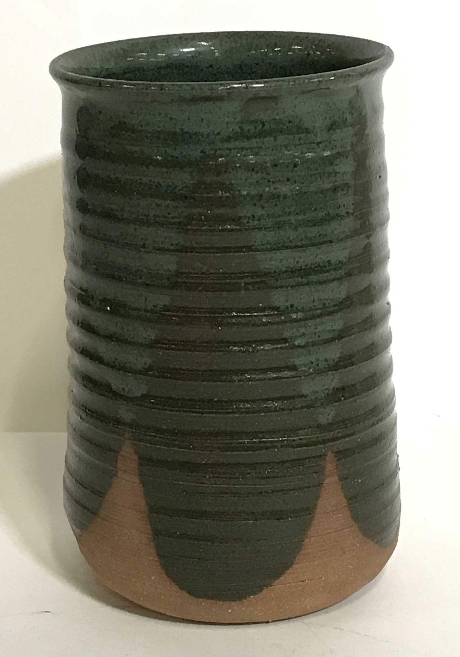 Vintage Modernist Style Signed Art Pottery Vase: A vintage art pottery partially glazed vase with a ribbed design on the body. The glaze colors of green overlap. It bears an incised signature on the bottom that reads (possibly) C. Ziman. This piece