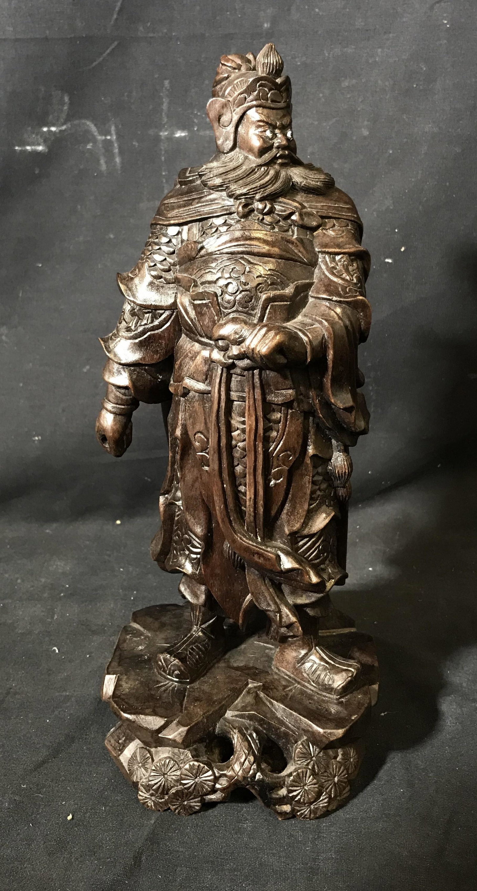 Wooden Far East Asian Statue: Wooden Far East Asian Statue, possibly Balinese, statue depicts a man in formal armor with added eyes facing in different directions, measures 12 inches at tallest point, hand carved from one block of
