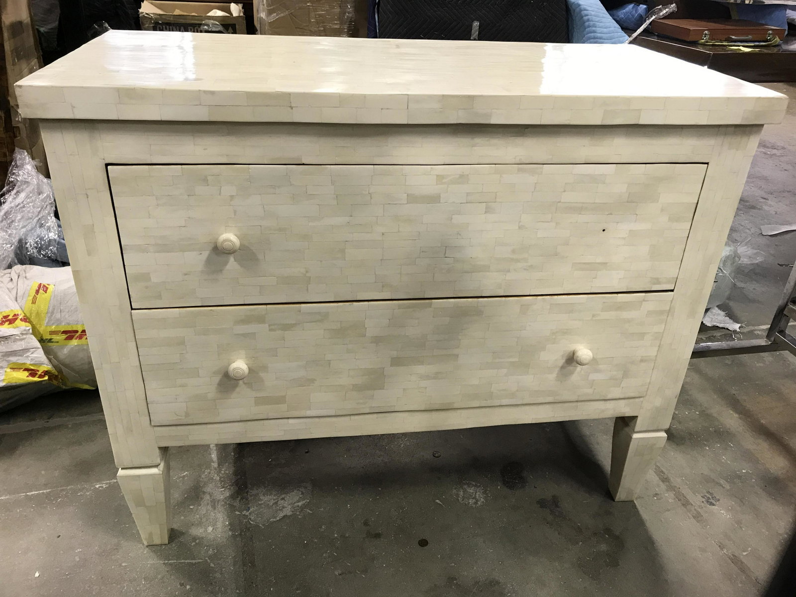 Inlaid Bone Mosaic Dresser: Dresser has inlaid bone mosaic. Piece is cream toned. Contains 2 drawers each with knob style handles. Piece measures approximately 42 inches long 34 inches tall 20inches deep. Dresser, mosaic dresser