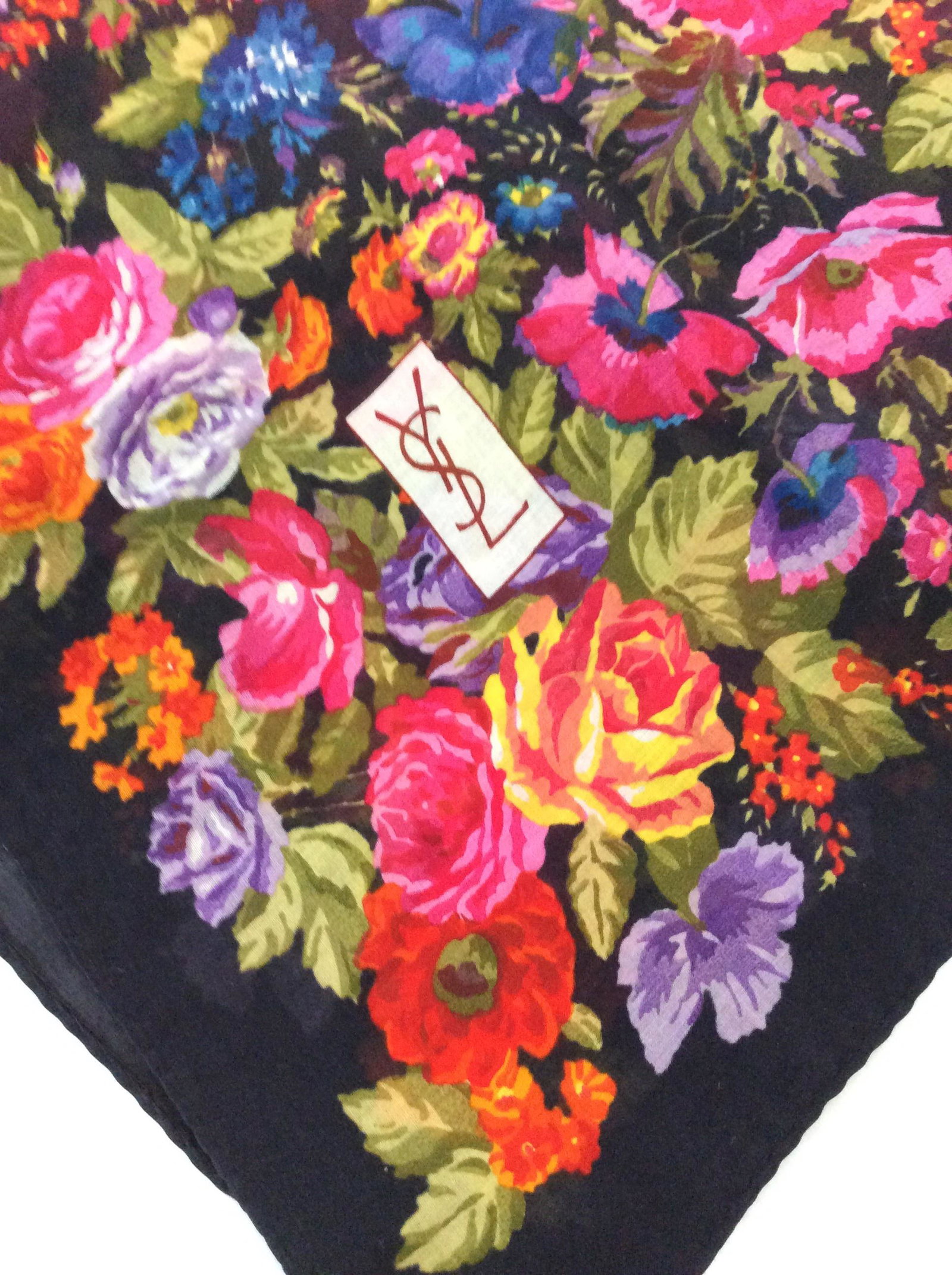Lot 2 Ladies Fashion Scarves, Luxury YSL: Colorful Cotton Yves Saint Laurent Square Scarf, brilliant floral on black. Signed ‘YSL’. 32 x 31 in. Additional white and tan block geo pattern Scarf, possibly rayon, measures 27.5 x 88 in. Luxur