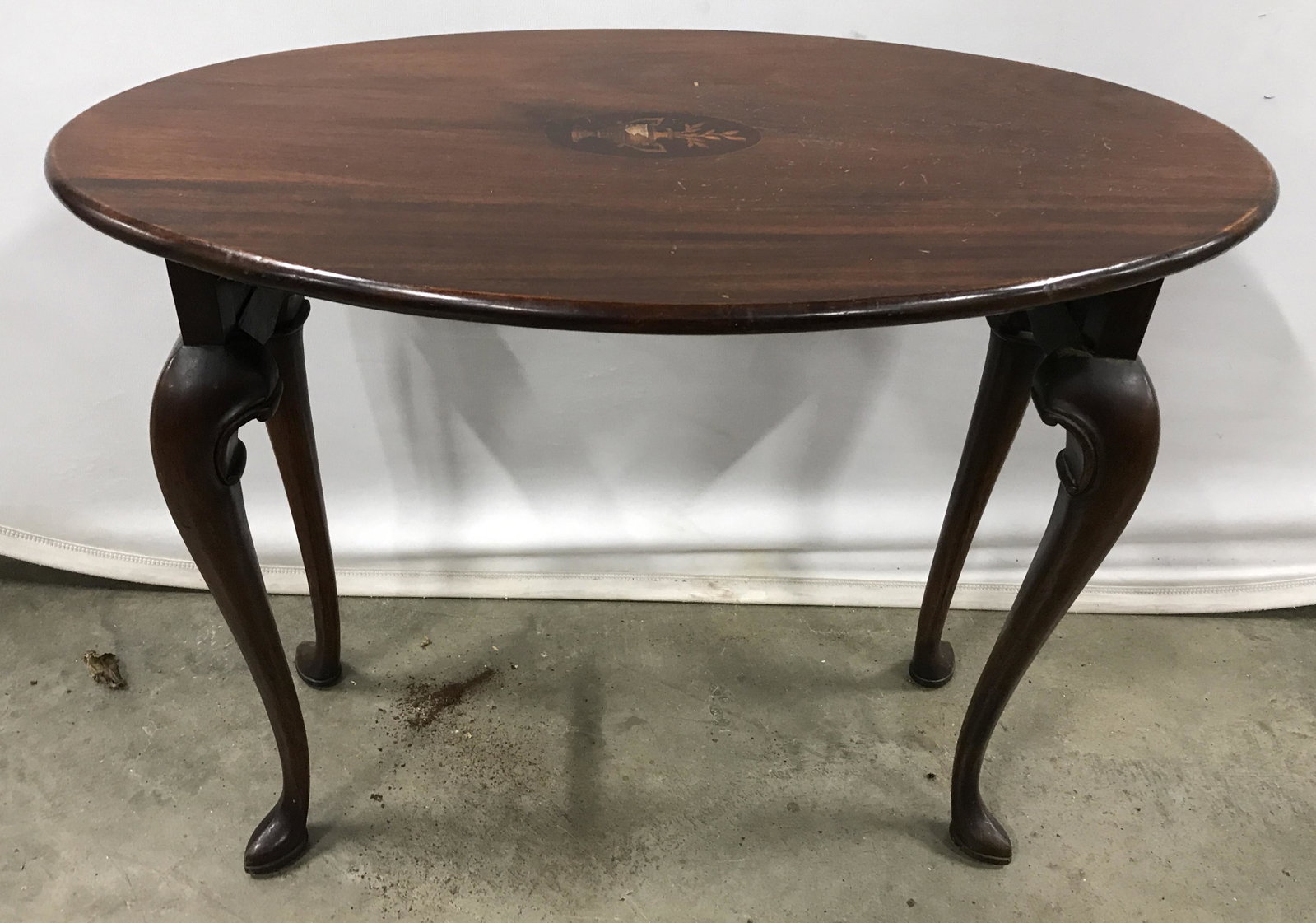 Carved Wood Inlay Side Table: Vintage side table, carved wood, inlaid wood detailing on table top, depicts potted plants. Legs are cabriole. Measures approx 20.5 inches H, and 26 inches W. Wear is consistent with age and use. Side