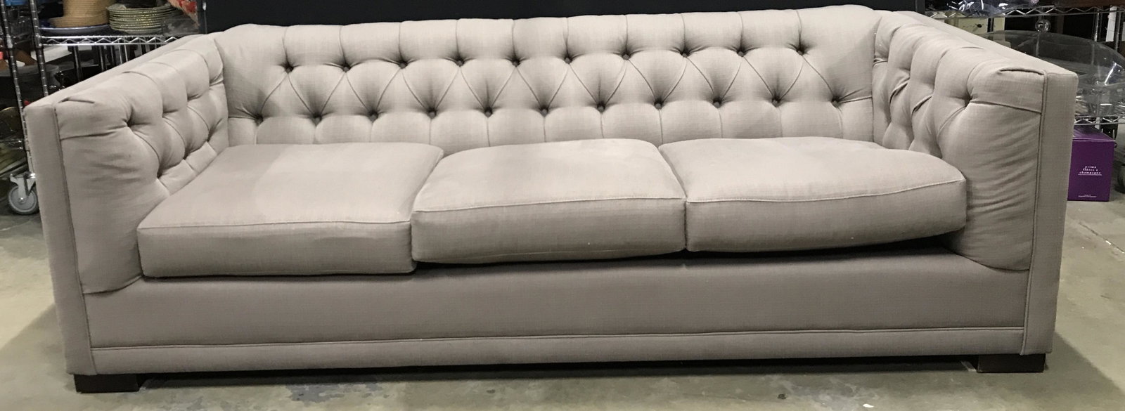 MCREARY MODERN INC Tufted Sofa: Underneath center cushion has tag which reads MCREARY MODERN INC. Piece has a brown slate tone. Back and armrests are tufted. Sofa measures approximately 85 Inches long 37 Inches deep 26 inches tall. 