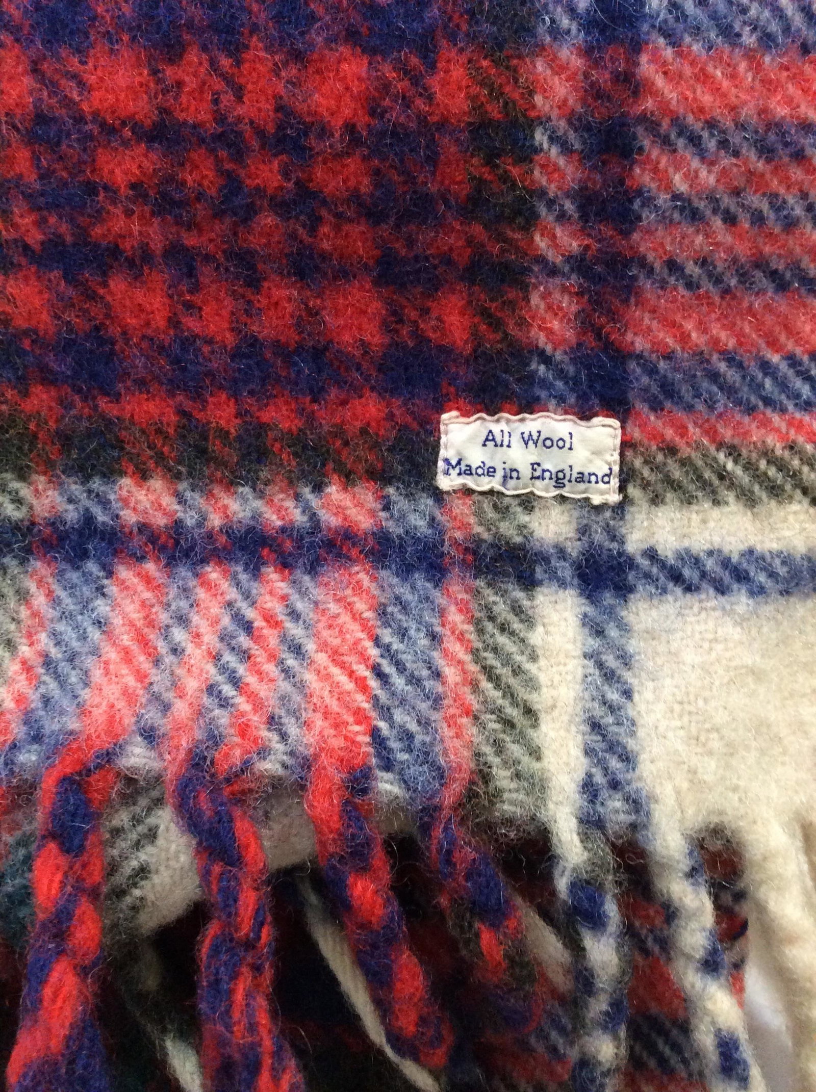 Plaid Wool Throw Blanket, Made In England: 34 x 49 in. Vintage wool. End fringe. Plaid with red white blue and green colors. No fabric issues noted. Has label, reads Wool, Made in England. Lap Blanket, Throw Blanket, Vintage Wool Toss Blanket,