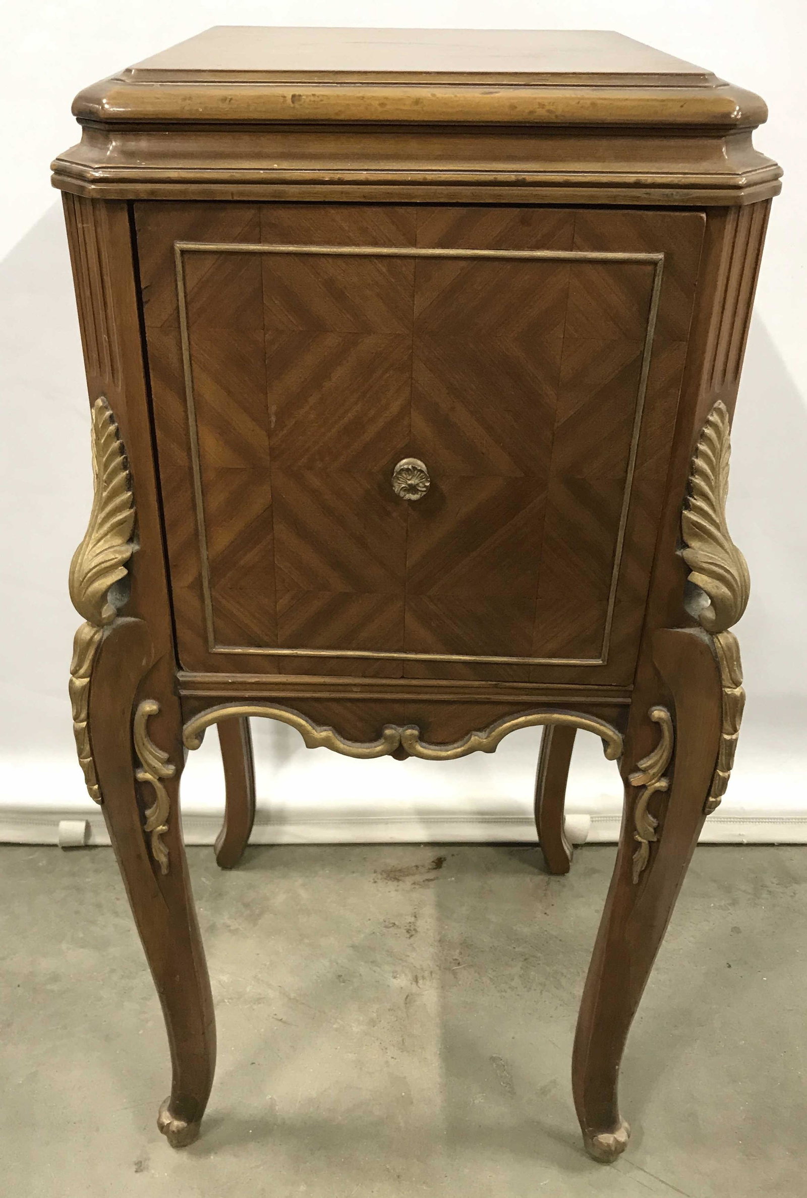 Louis XVI Style Nightstand: Vintage night stand Louis XVI style. Carved wood detailing along from legs, detailing is highlighted by gilt paint, drawer joints are dovetailed. Door pull is brass, a drawer can be found in the stand