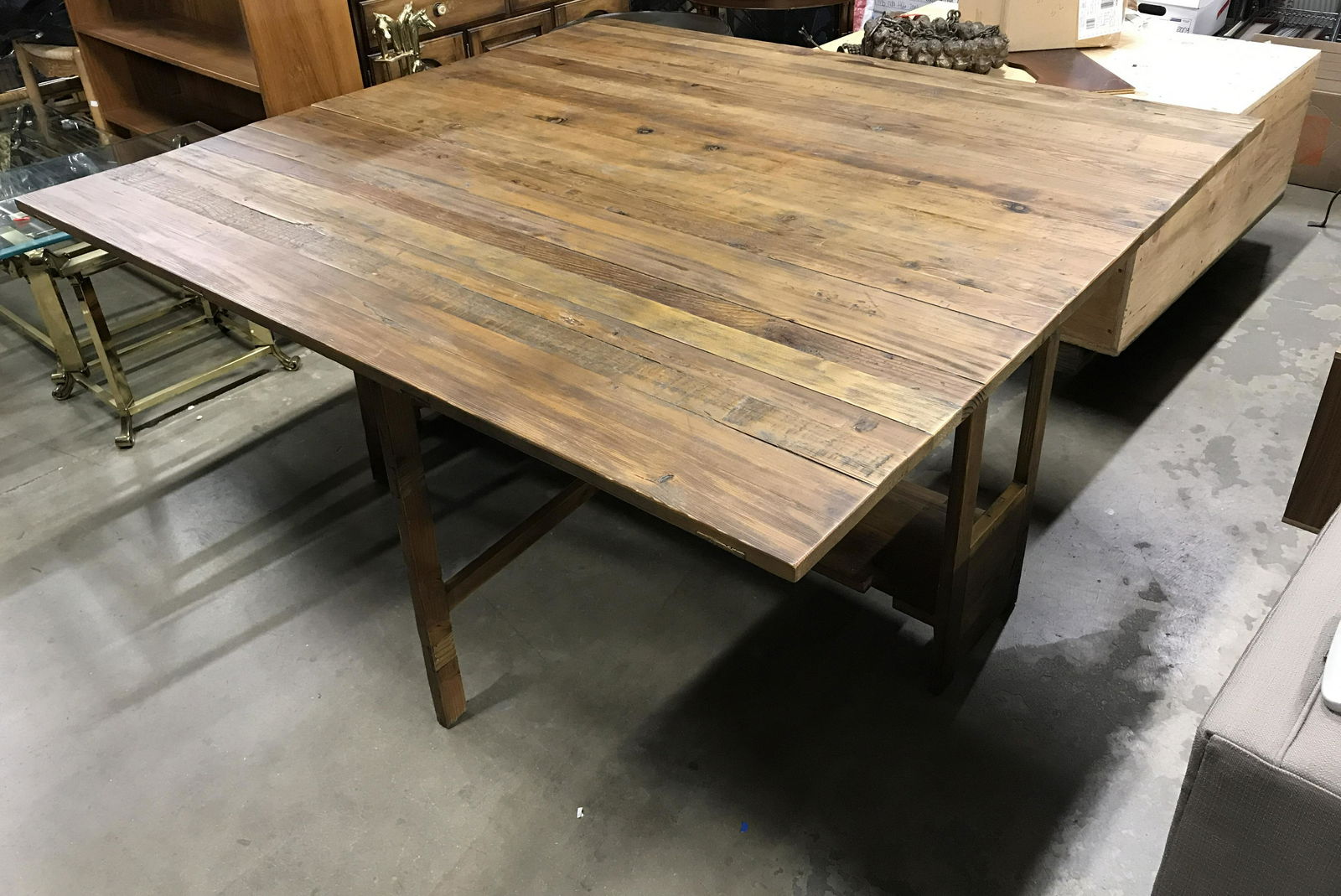 Vintage Rustic Drop Leaf Dining Room Table: Vintage dining room table, extendable through the use of leaves. Leaves are supporting by stands that swing out from tables legs. Measures approx 30.75 inches H, 65.25 inches W, 61 inches deep, with l