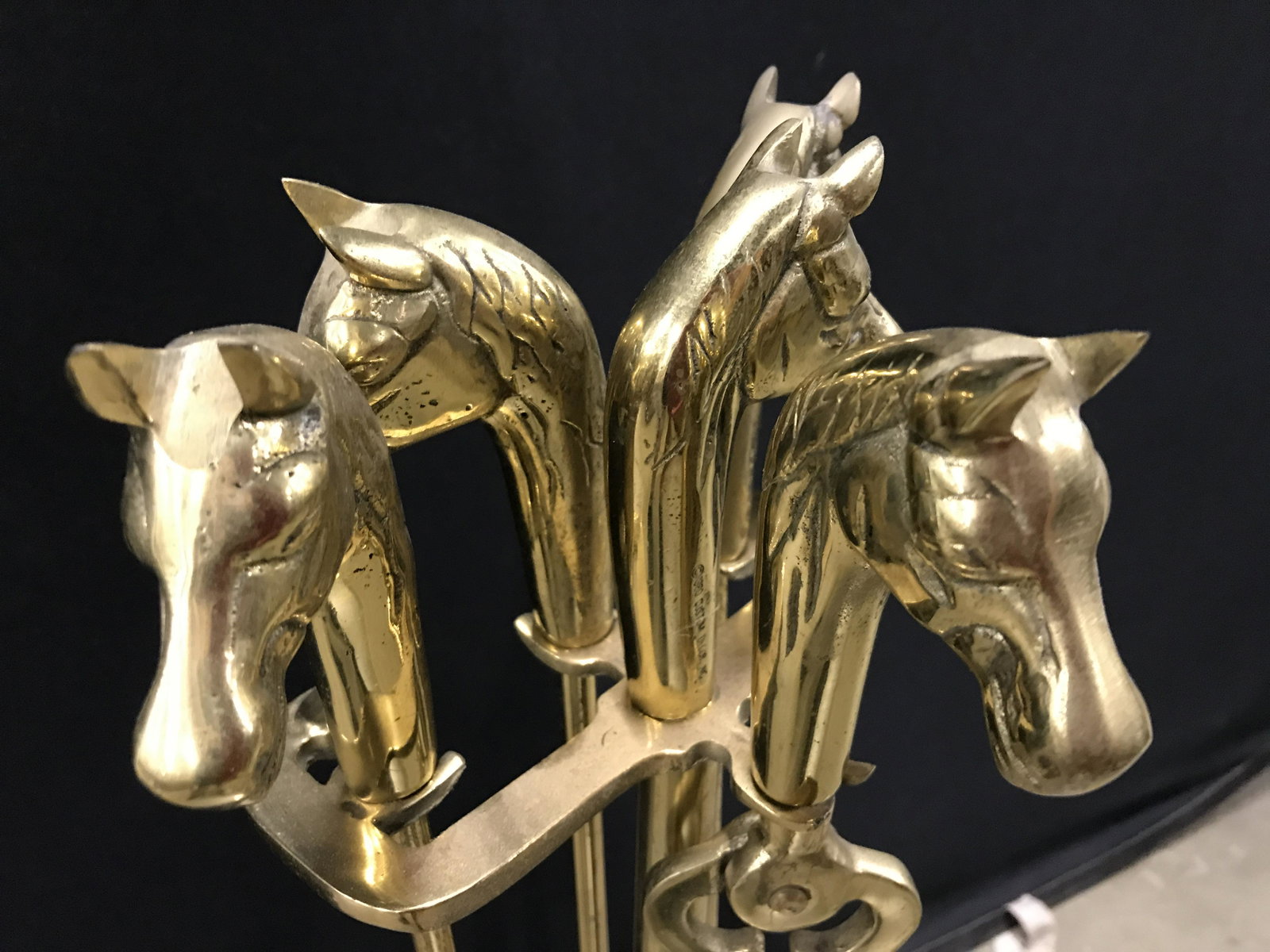 Set 5 Brass Fireplace Accessories: Set 5 vintage brass fireplace tools. Each tools handle has been crafted to resemble a horse’s head. Includes a poker, broom, tongs, rack, and a shovel. Wear is consistent with age and use. Largest p