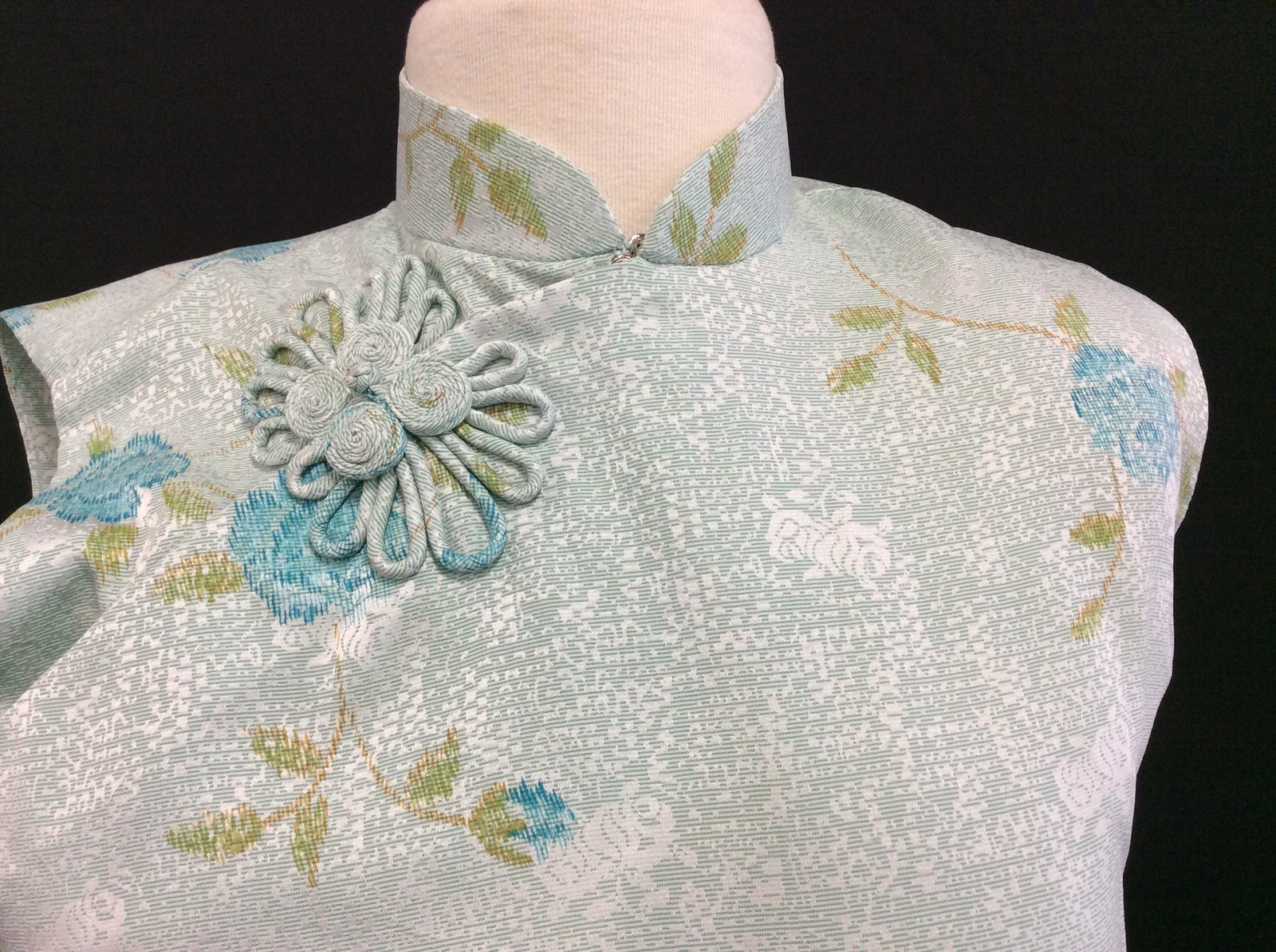 Pair Chinese QIPAO Sleeveless Dresses: Light aqua blue with blossoms, Sz Small, Zipper On Side, snaps up Chest to Neck, side slit for walking. Other dress cream color with green Asian fan design. Both App 53 in long. Both lightweight and s