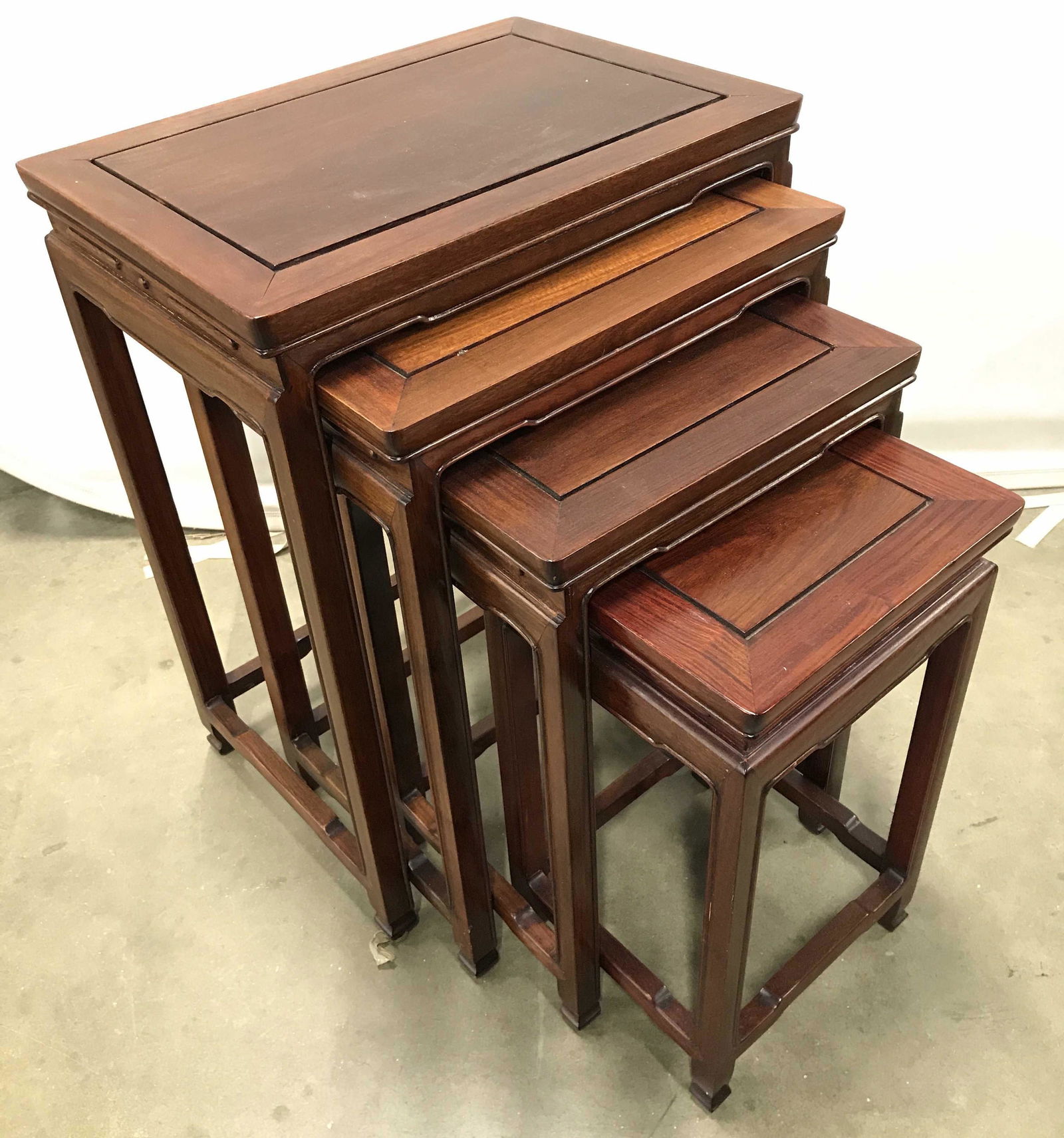Set 4 Vintage Carved Asian Nesting Tables: Lot includes 4 nesting tables. Each are mahogany toned. Tables appears to possibly be hand carved. Tables are vintage possibly antique. Largest piece measures approximately 26 inches tall 20 inches wi