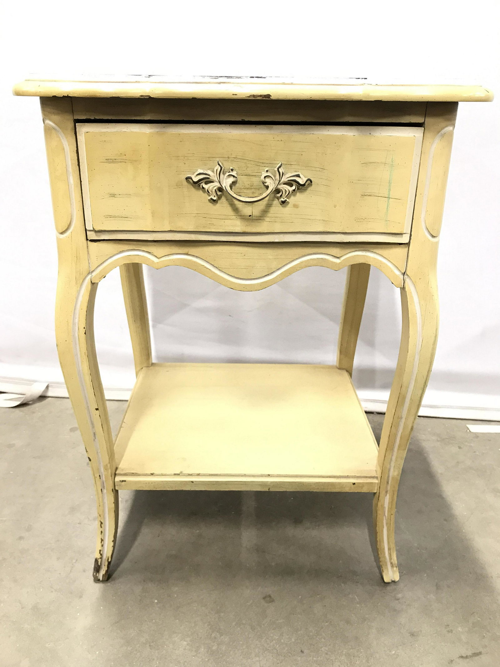 Vintage Yellow Toned Wooden Nightstand: Nightstand is has yellow, banana cream tone. Piece has 1 drawer. Drawer has ornate handle. Drawer has hand dovetailing. Piece measures approximately 25 inches tall 18 inches wide 15 inches deep. side 