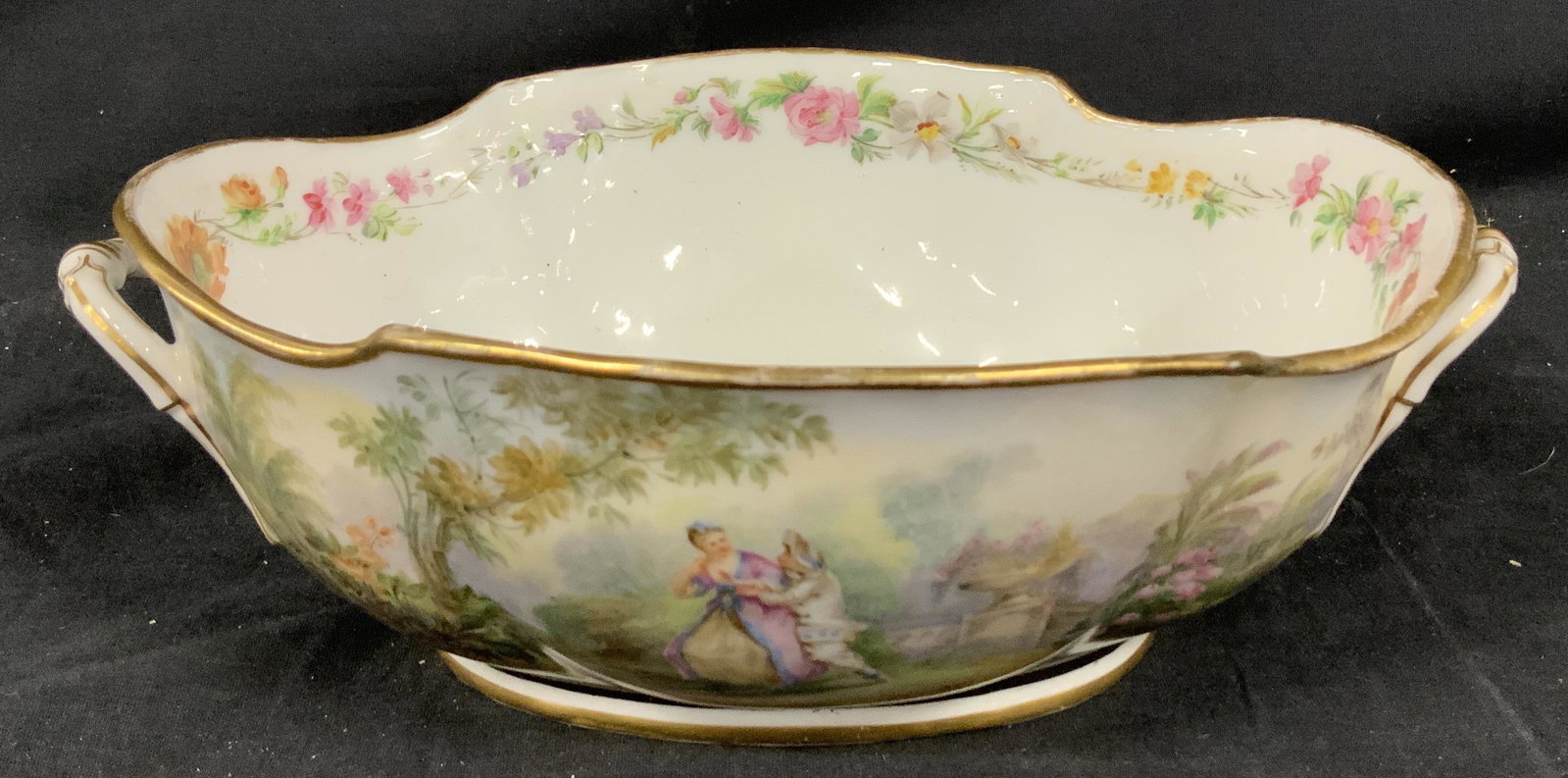 Signed Decorative Ceramic Centerpiece Bowl: Decorative Ceramic Bowl, inscription to base reads ‘N LM, floral pattern to interior of bowl, scenes of people in gardens to exterior, measures 11 1/8 Inches at widest point x 3 3/4 inches tall, som