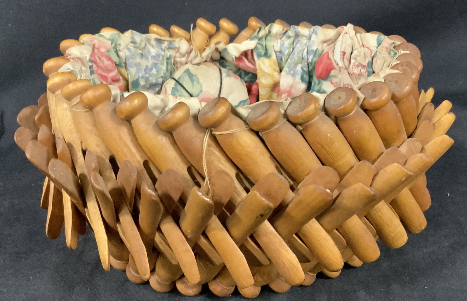 Vintage Clothespin Basket: Vintage Clothespin Basket with attached pin cushion, no apparent inscriptions or stamps, floral fabric to interior, measures 4 5/8 inches tall x 9 3/4 inches in diameter, some wear to basket and fabri