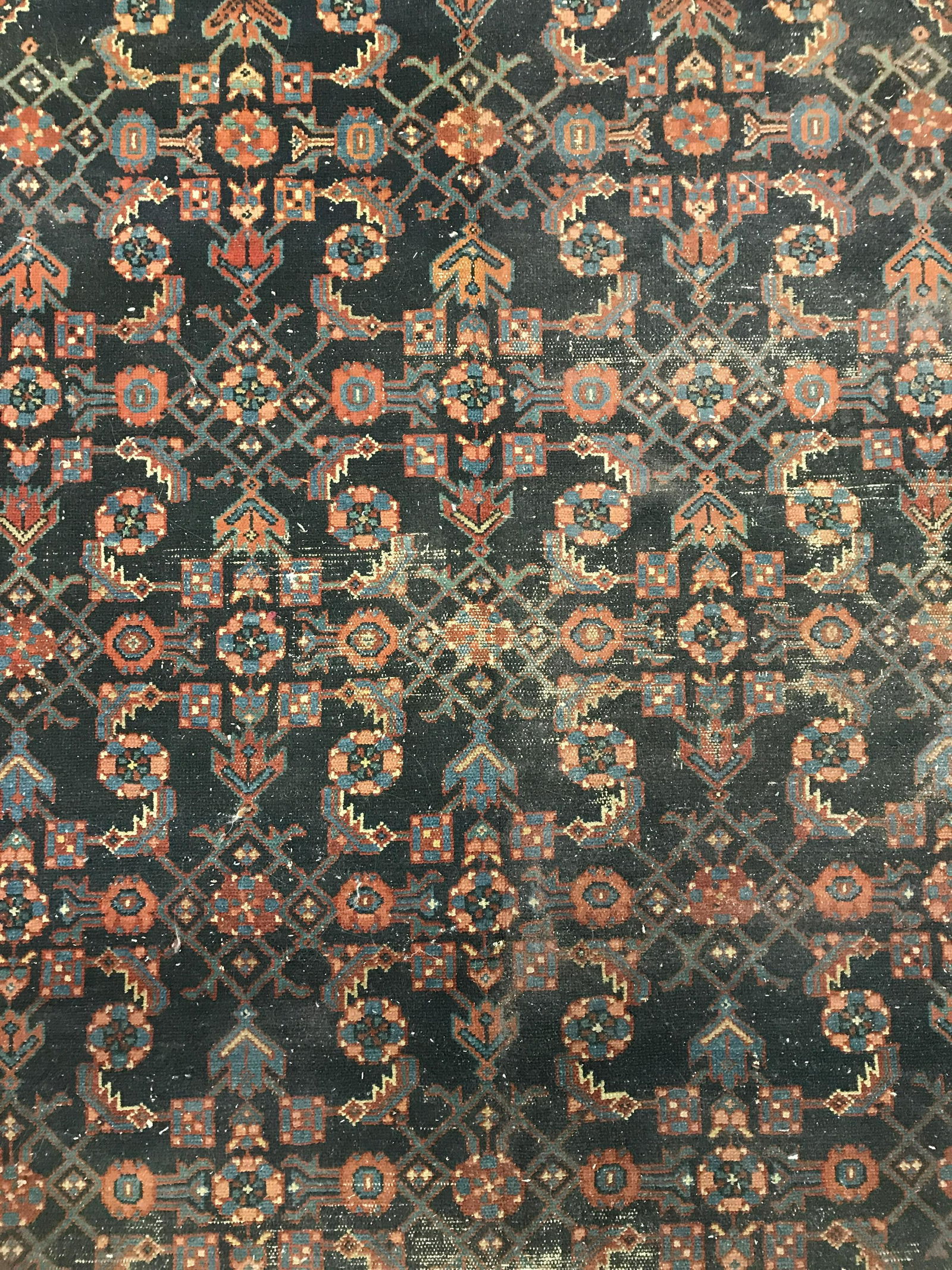 Antique Handmade Persian Wool Rug: Rug is wool and handmade. Piece appears to be antique. Contains multi toned floral leaf & geometric detail. Piece measures approximately 75 inches long 57 inches wide. Rug, carpet, area rug, wool rug,