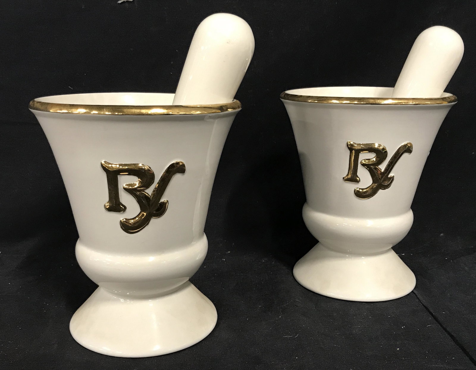 Pair Porcelain Rx Mortar & Pestle: Pair Porcelain Rx Mortar and pestles, both have the Rx symbol to the front facing side, rim and Rx symbol to both painted gold, both mortar measure 7 inches tall and 6 inches in diameter at the rim, b