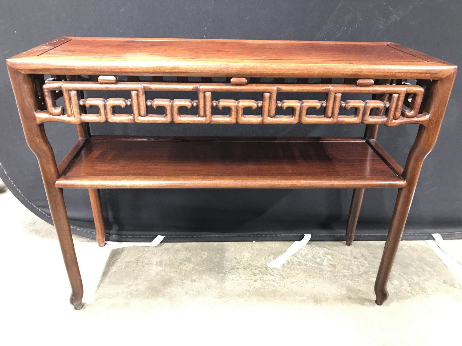 Vintage Asian Carved Wooden Console Table: Console table is vintage possibly antique. Piece has carved wooden feet, and carved wooden detail directly under tabletop. Piece has shelf space underneath tabletop. Table has Asian style. Piece Measu