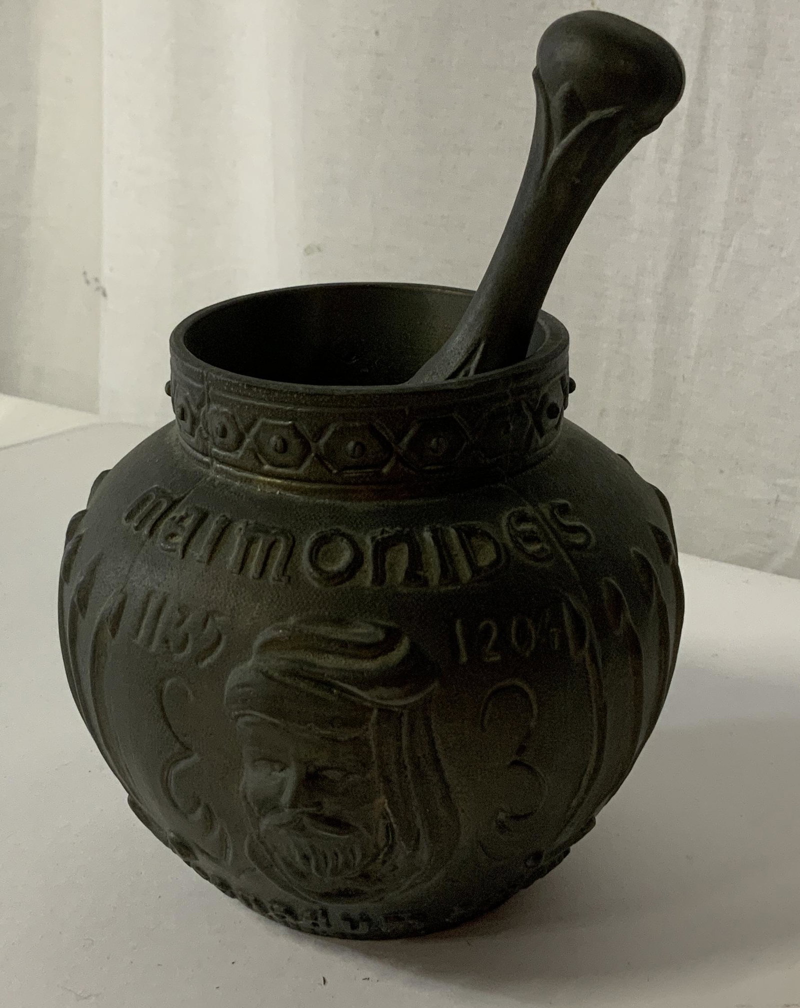 Coricidin Metal Mortar and Pestle: Coricidin Metal Mortar and Pestle, inscription to pestle reads ‘Coricidin’, inscription to mortar reads ‘Maimonides 1135 1204 secundem artem RX’, pestle with embossed designs and a man’s fac