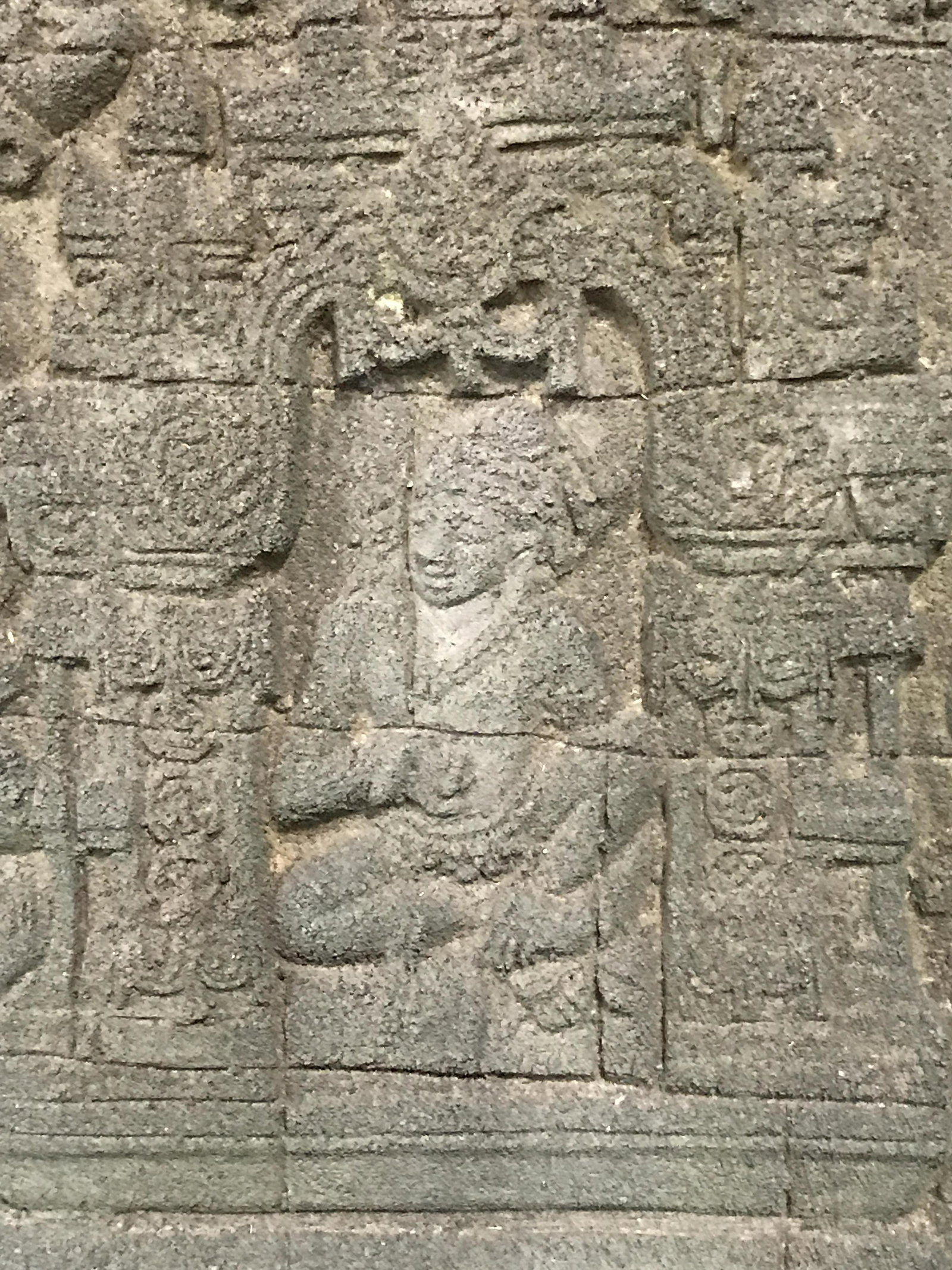 East Asian Stone Carving Art: East Asian Stone Carving, no apparent signatures or stamps, subject a scene of a seated figure within an arch being approached by guards and servants, carved on a dark porous stone, hung in a dark woo