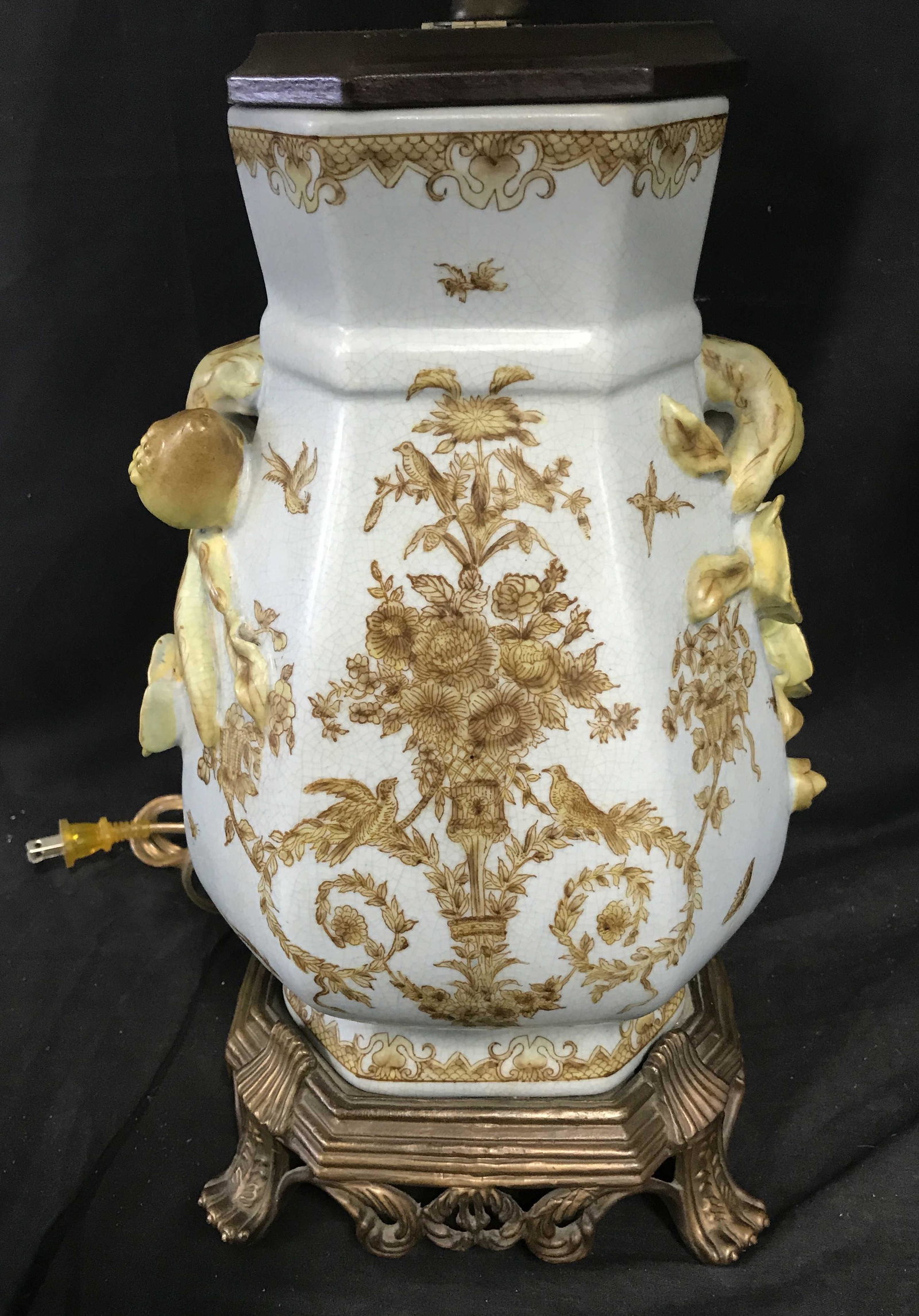 Pair Vegetal Rococo Lamps: Pair Vegetal Rococo lamps, both are made of blue ceramic with vegetal designs to the body and handles, body of both lamps are shaped like vases, both have bronze colored metal bases, both have bronze 