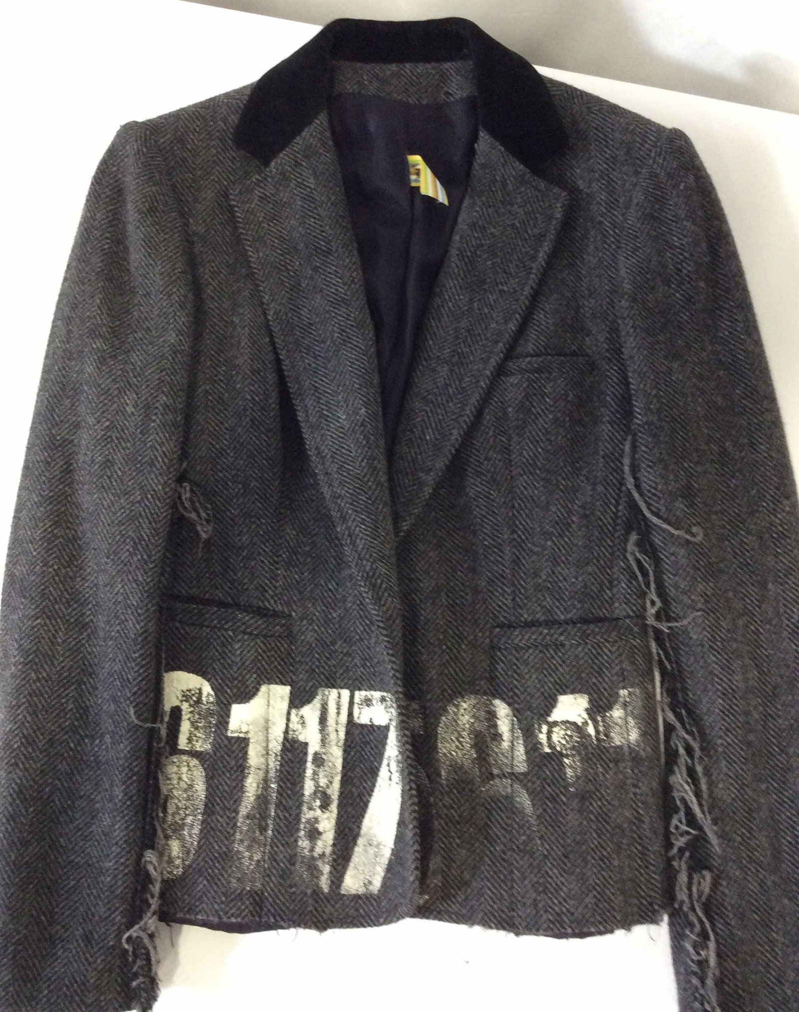 LIBERTINE WOOL Bohemian Tweed Blazer: Labeled designer, label reads ‘LIBERTINE JOHNSON HARTIG & CINDY GREEN. Velvet Collar, chevron pattern in grey wool, Fringed hems, pockets. Lower lining hem needs to be re sewn to jacket. Sz Small. C