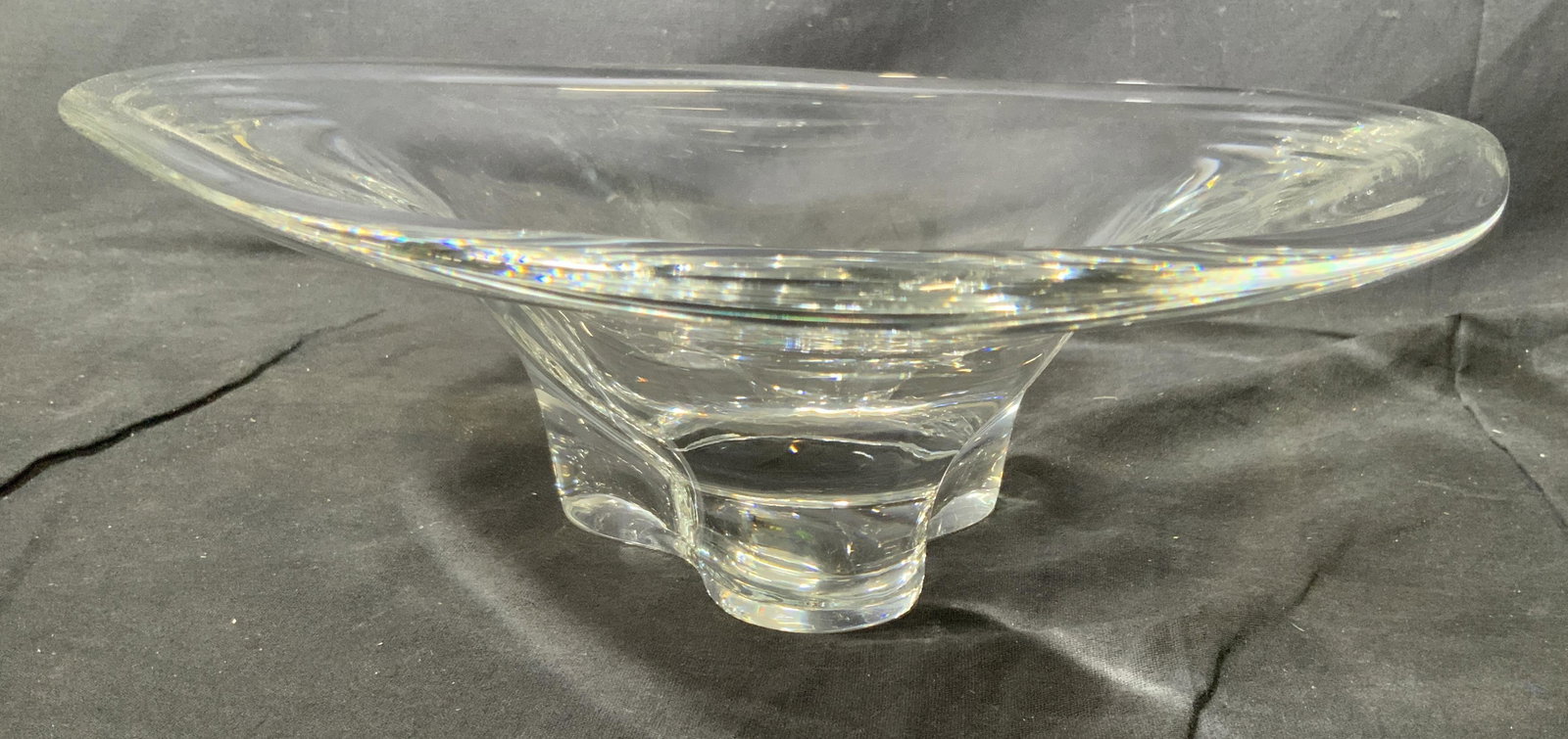 Orrefors Sweden Crystal Art Glass Bowl: A vintage Orrefors Sweden crystal art glass biomorphic shaped footed bowl. This piece is signed and numbered on the underneath. There is no apparent damage. This piece measures approximately 14 inches
