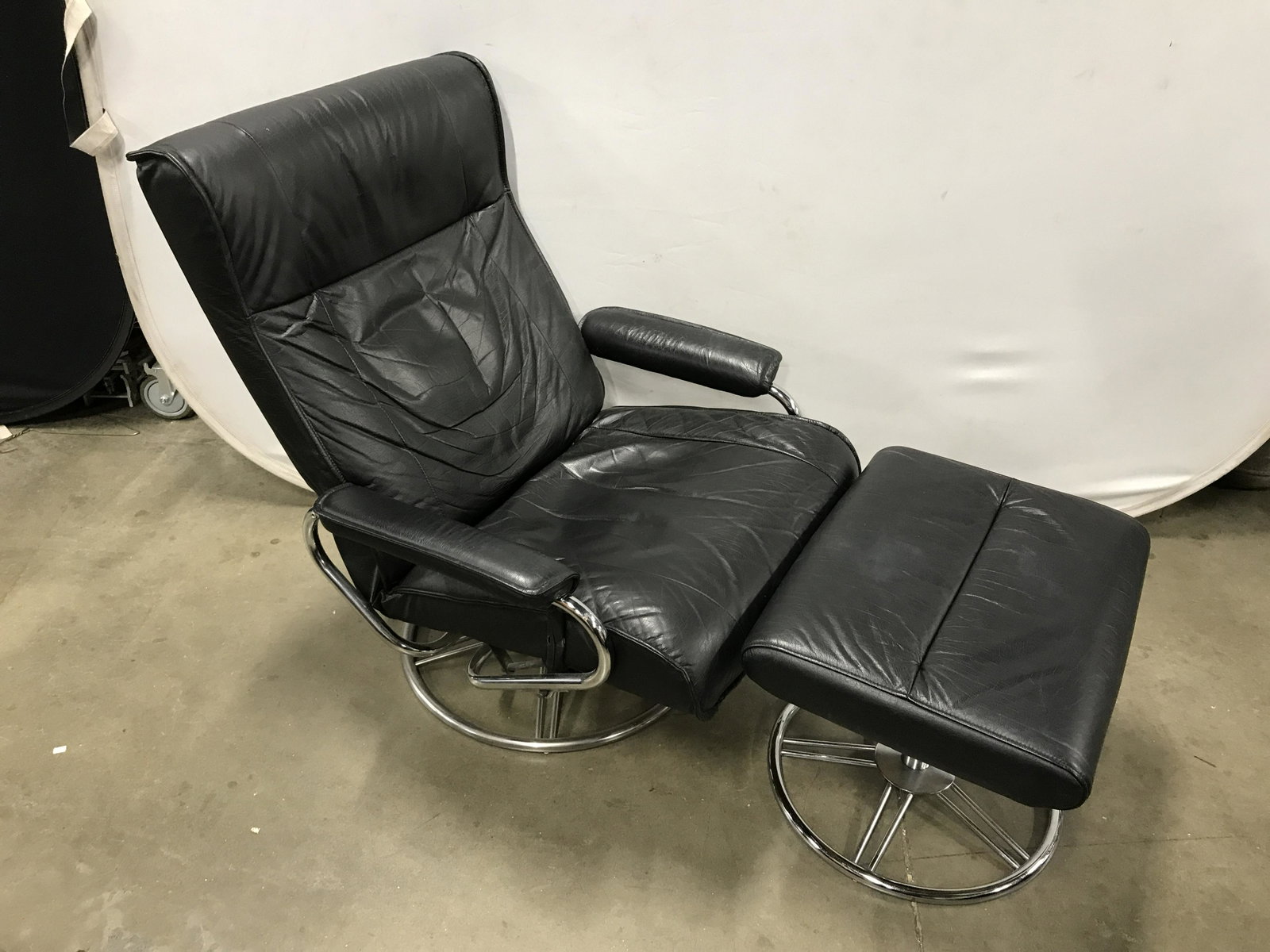 MCM Vintage KEBE Leather Chair With Ottoman: Vintage arm chair with matching ottoman. Chair reclines, and sits low. Both the ottoman and chair are crafted from leather on metal frames. The largest piece measures 35 inches H, and 29.75 inches W, 