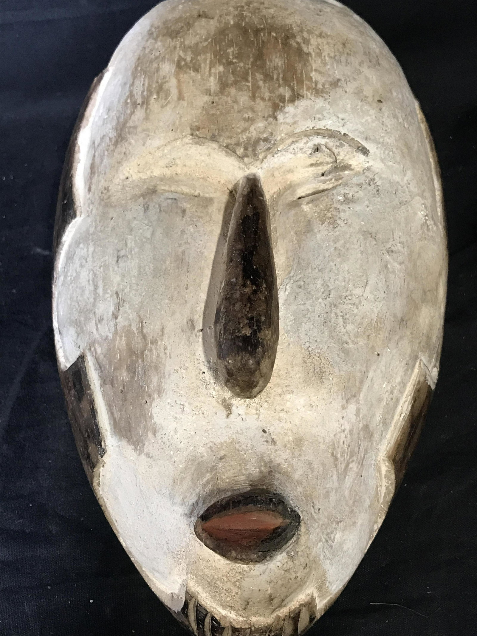 Nigerian Yuruboh White Mask: Nigerian Yuruboh White mask, origins can be found in Nigeria West Africa, colored white and brown pigment, hand carved from single block of wood, measures approximately 11 inches at tallest point and 