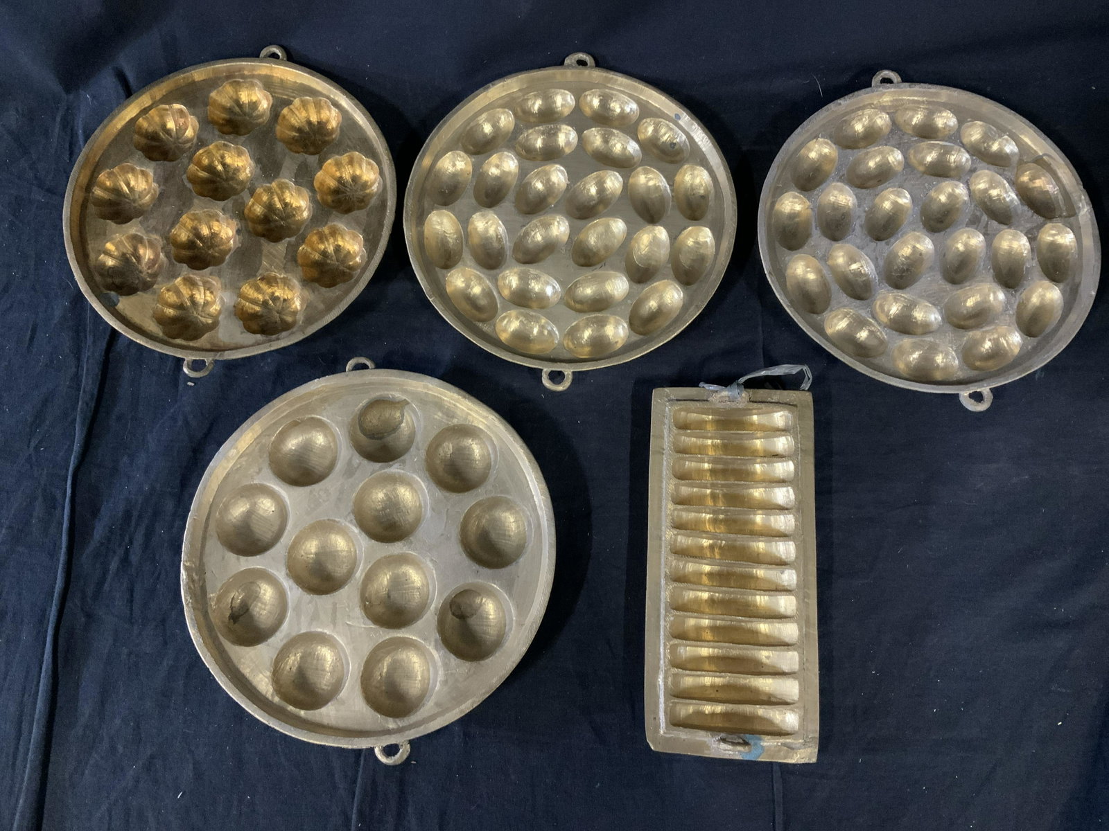 Lot 5 Vintage Metal Chocolate Molds: Lot 5 Vintage Metal chocolate molds, no apparent inscriptions or stamps, molds with varying shapes, circular molds measure 9 1/8 inches in diameter, rectangular mold measures 9 inches x 4 1/8 inches, 