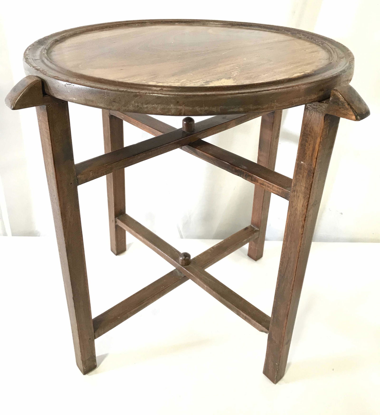 Vintage Folding Round Top Wooden Side Table: Side table wooden support structure folds. Piece has top which is separate from base. Piece is vintage possibly antique. Piece measures approximately 20.5 inches tall 18 inches wide. Side table, end t