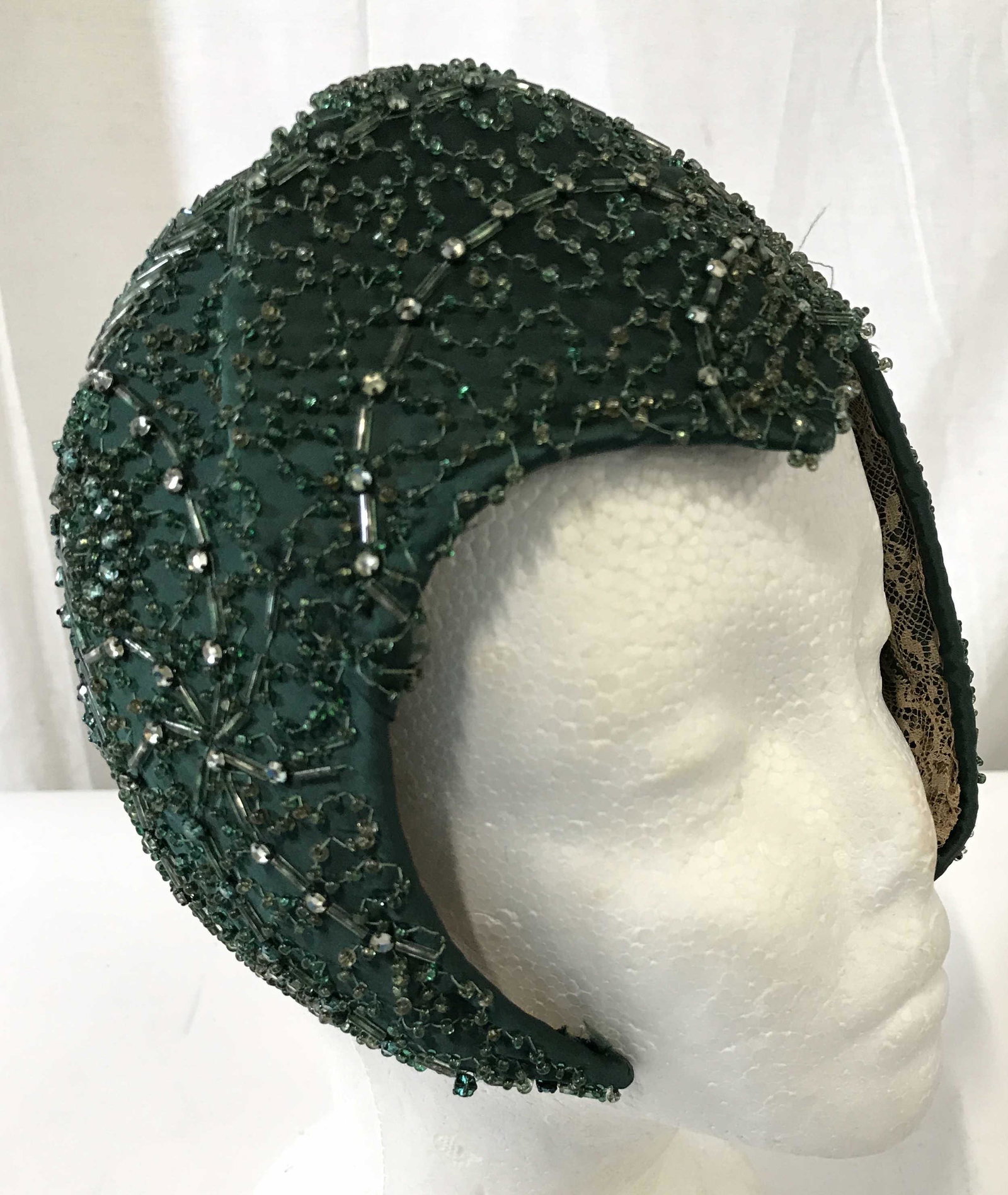 Vintage Green Toned Beaded Women’s Headpiece: Head piece appears to be vintage. Piece has arch shape with widows peak shape in middle. Head piece is green toned and beaded. Piece measures approximately 7 inches 6 inches Wide 4 inches deep. Headpi