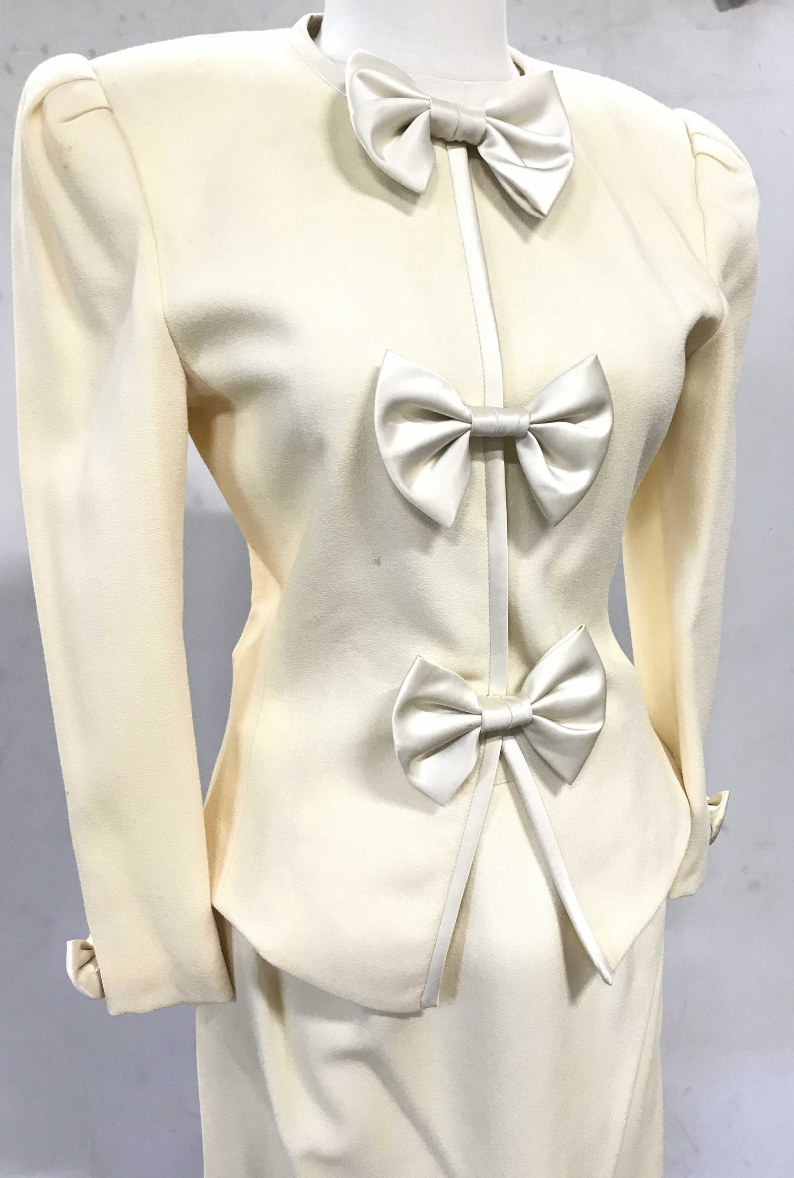 Vintage Albert Nipon Wool Skirt Suit: Blazer has snap buttons with bows, size 4 both blazer and skirt, cream wool, labeled 100% wool, Lined, fitted skirt with back zipper. Vintage Fashion, C. 1980s, luxury vintage Designer brand, Albert N