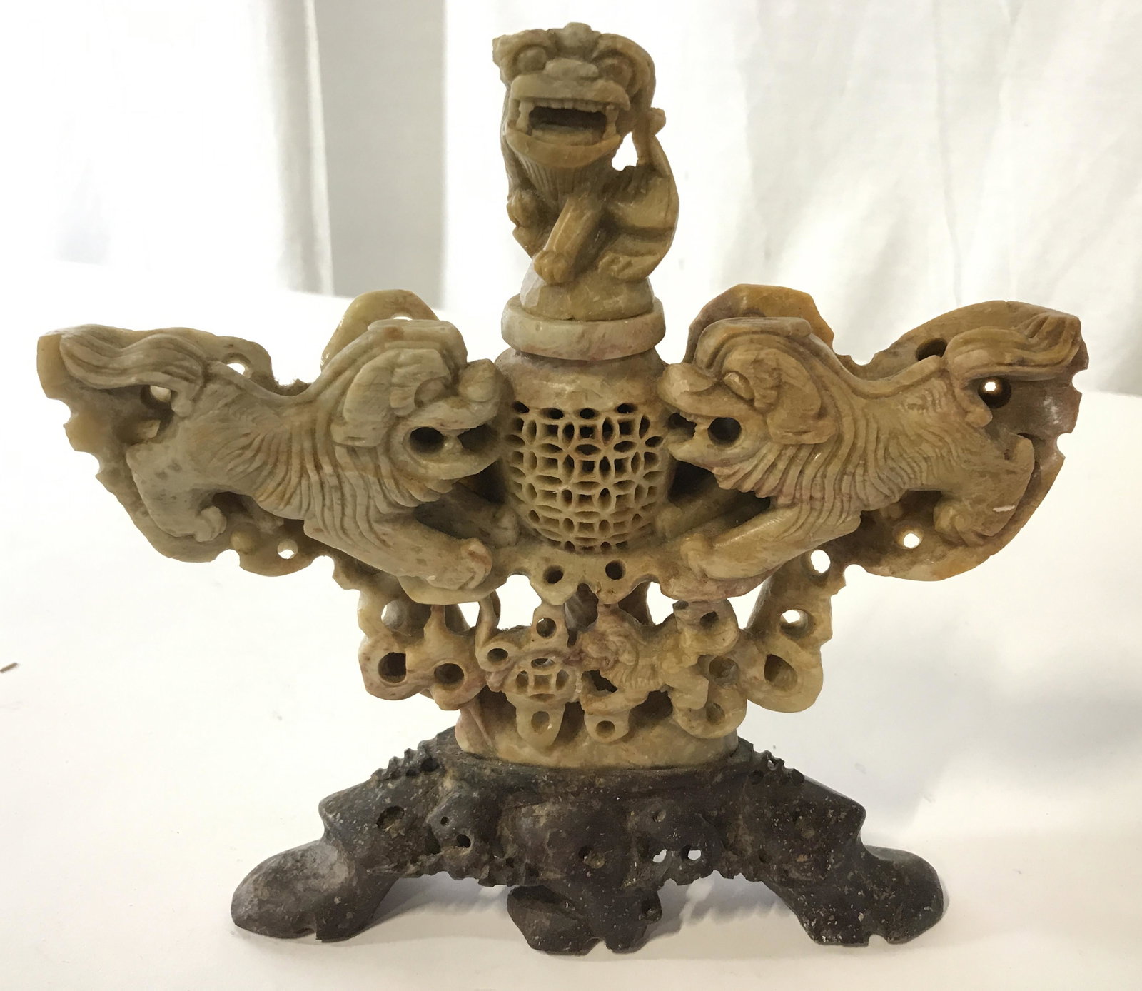 Vintage Carved Stone Foo Dog Sculpture: Vintage, possibly antique, Carved stone Foo dog sculpture. Depicts several Foo dogs flanking and urn from all sides. Base is carved from stone as well. Measures approx 7.5 inches H, and 8 inches W. We