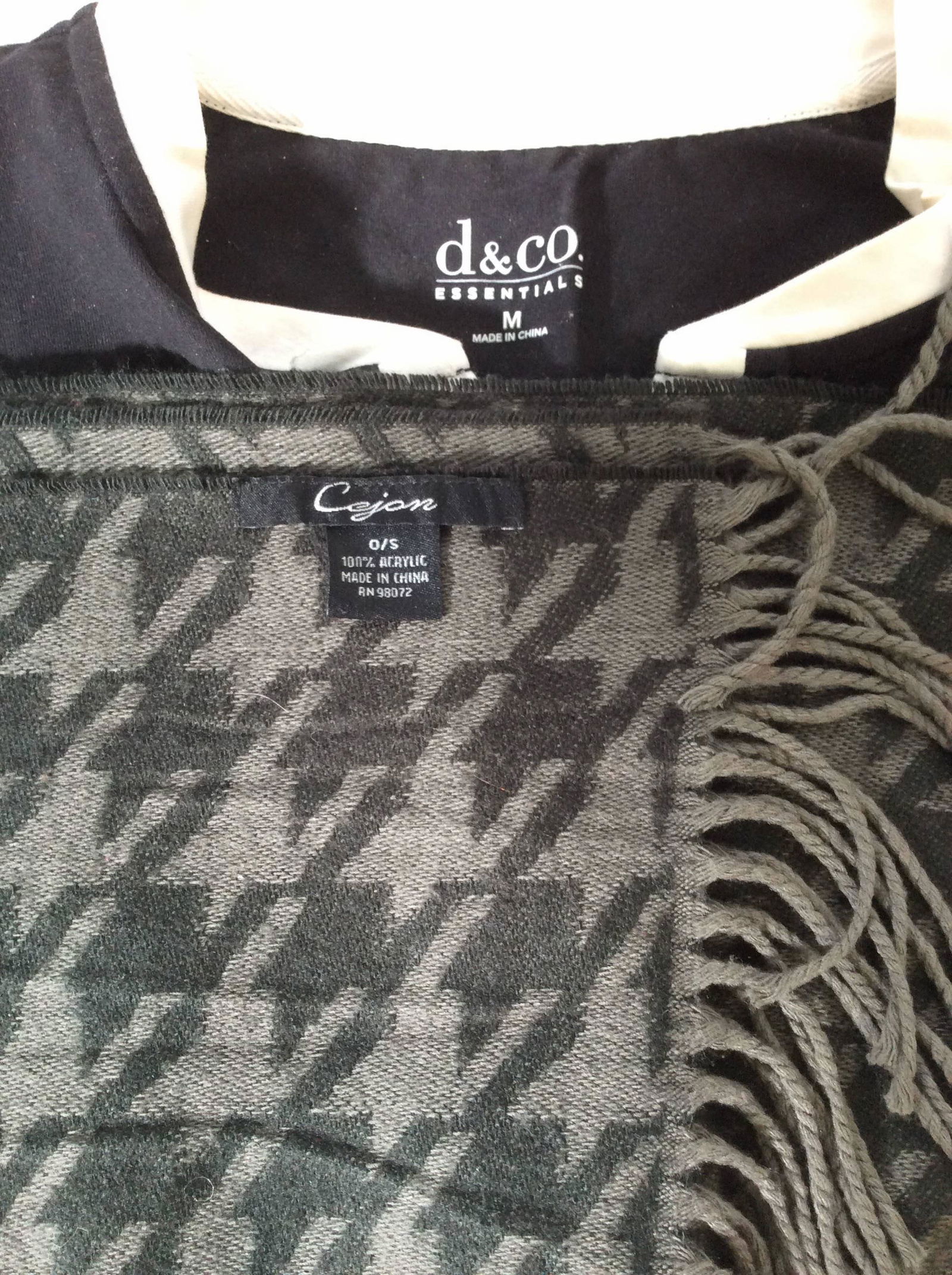Lot 2 Ladies Designer Top And Scarf: blouse label reads d & co essentials. Black cotton top with stretch, white crew collar, Sz Med. acrylic hounds tooth scarf labeled CEJON. Grey and black, 12 x 64 in. Comes with plastic HERMÉS Care Ba